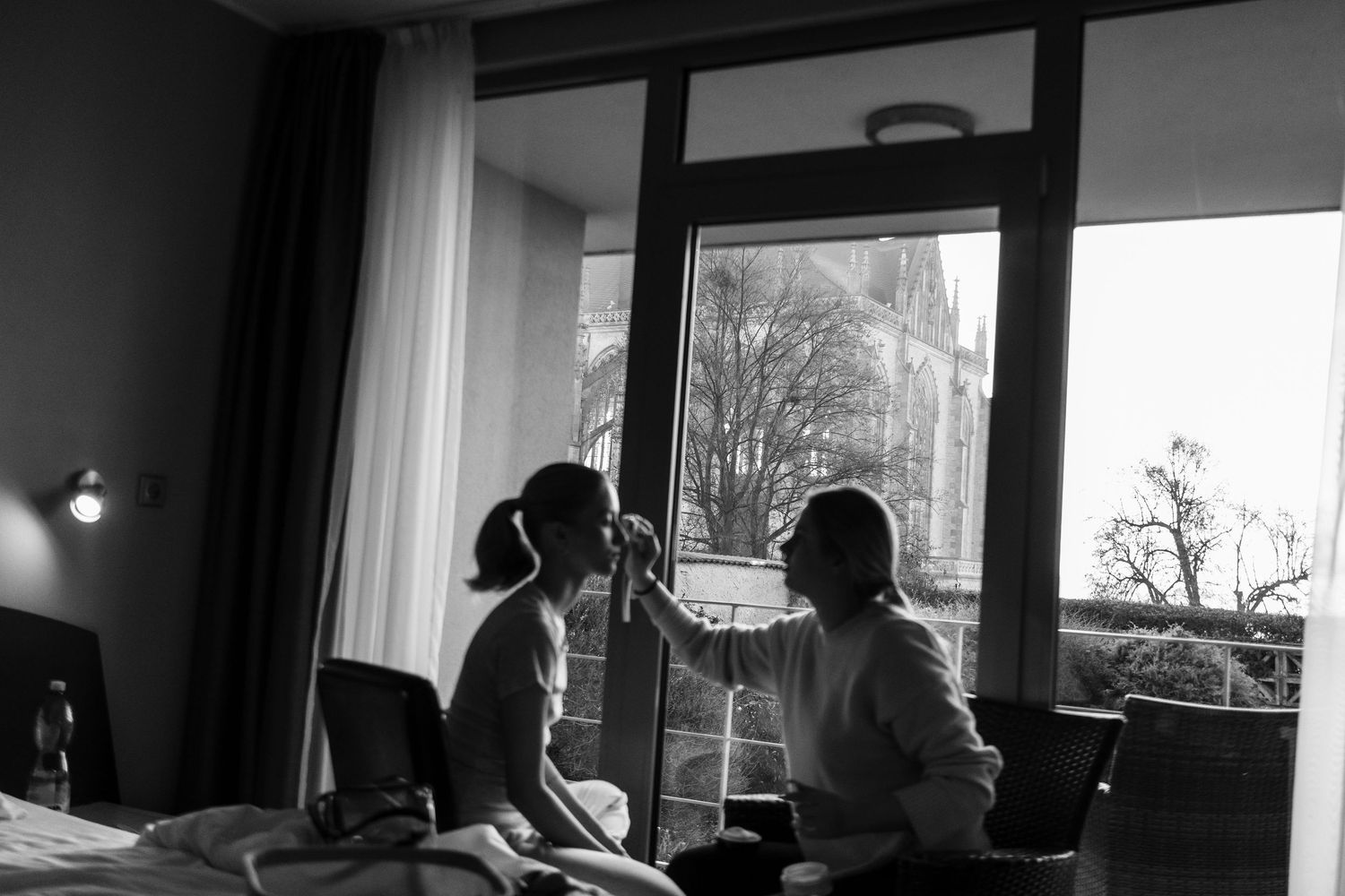 Black and white panoramic photo showing silhouettes of people in a bright modern interior space.