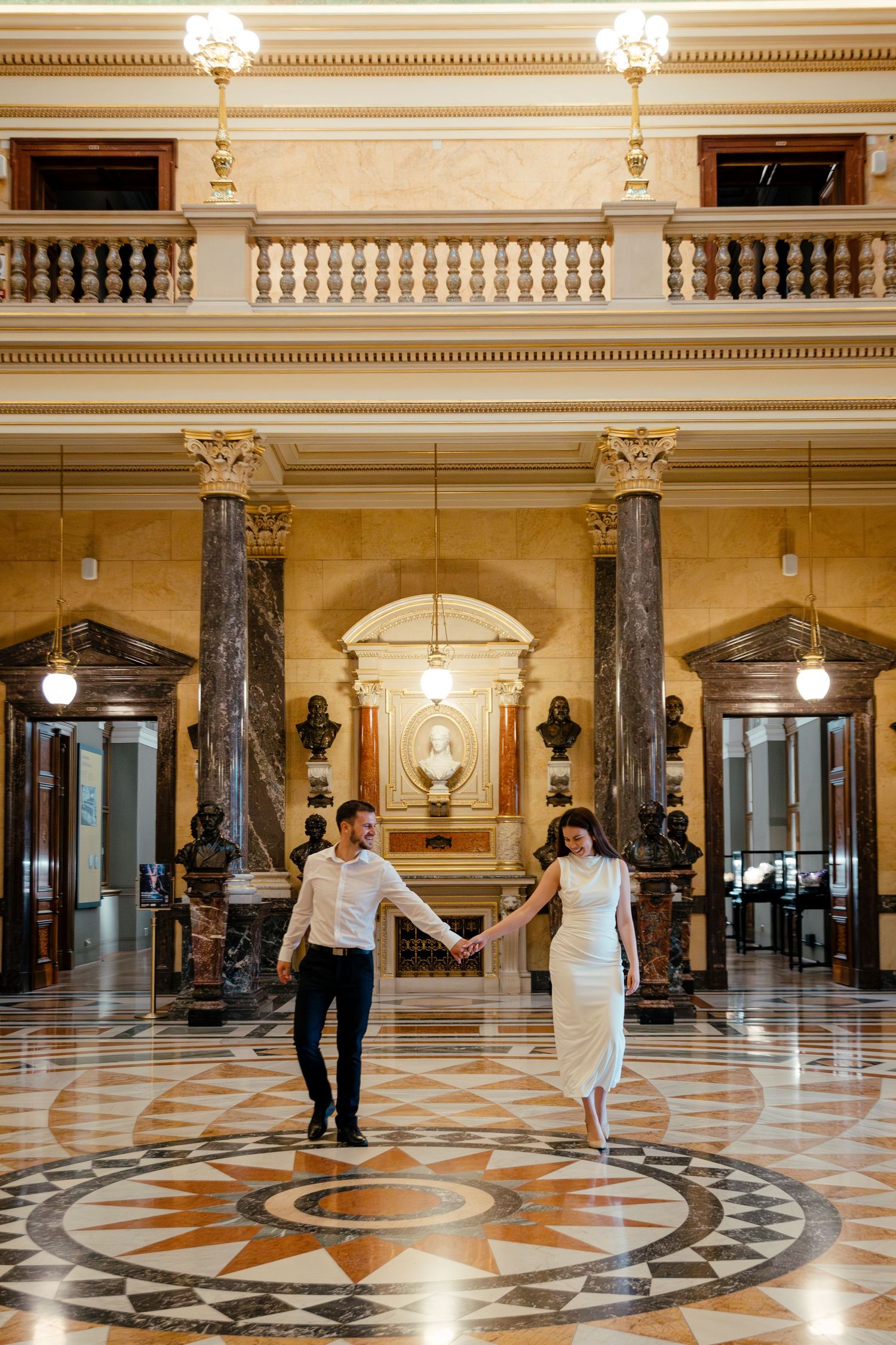 Elegant marble floor pattern in grand hallway with ornate architectural details and decorative columns.