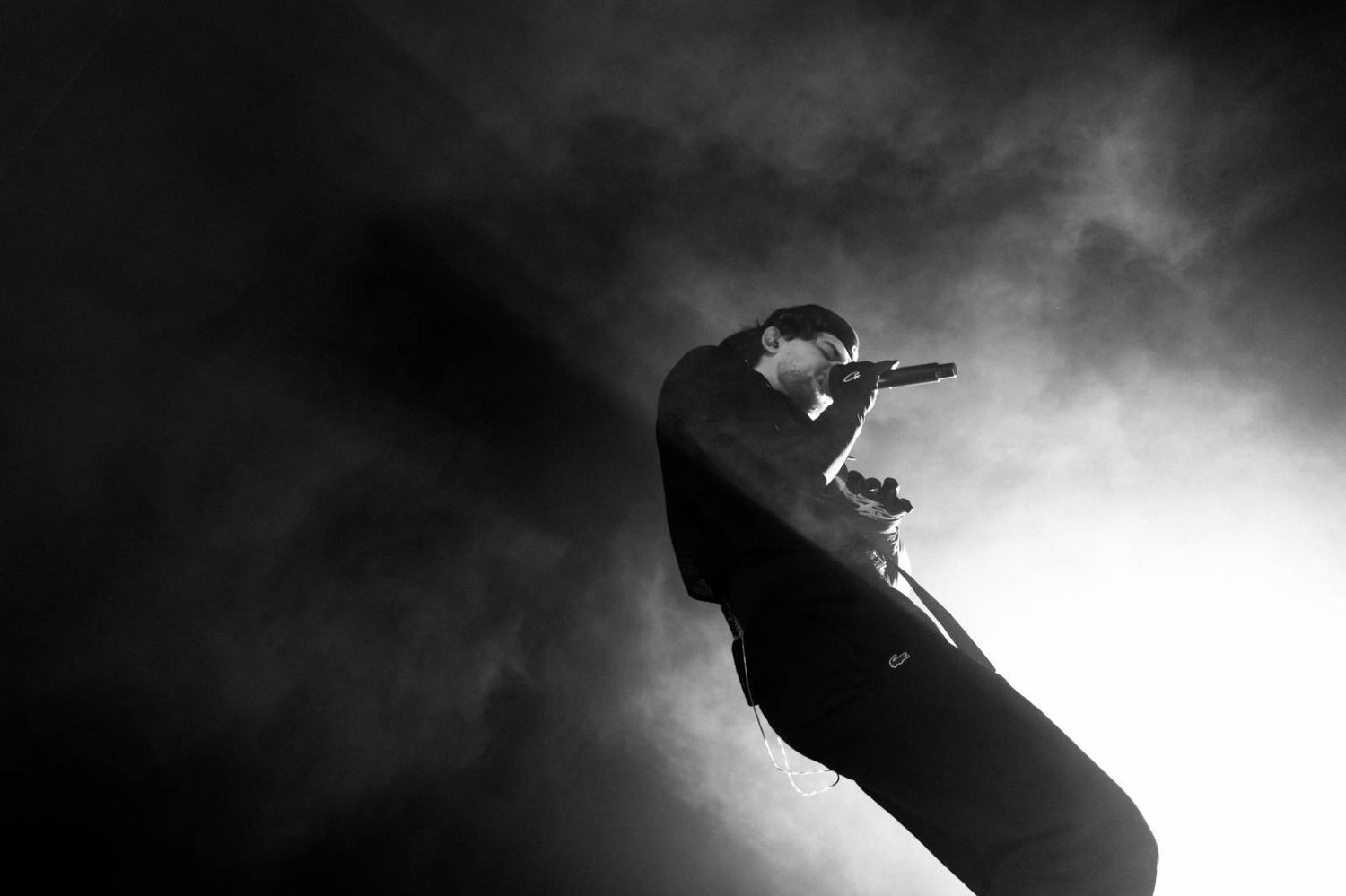 Silhouetted figure performs an impressive skateboarding trick against a dramatic smoky background.