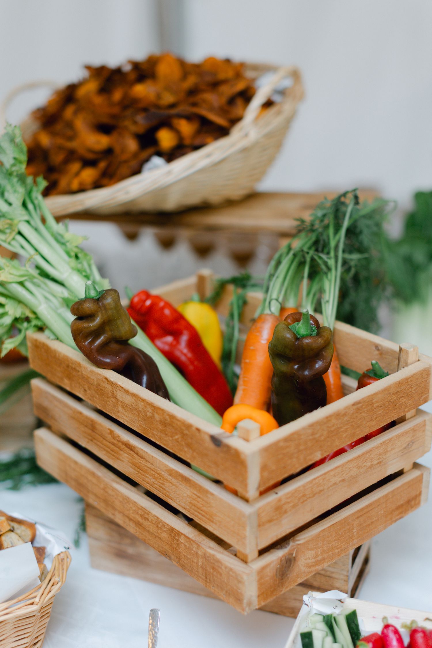 Légumes frais colorés dans une caisse en bois avec des poivrons, des carottes et des légumes verts à la réception de mariage.