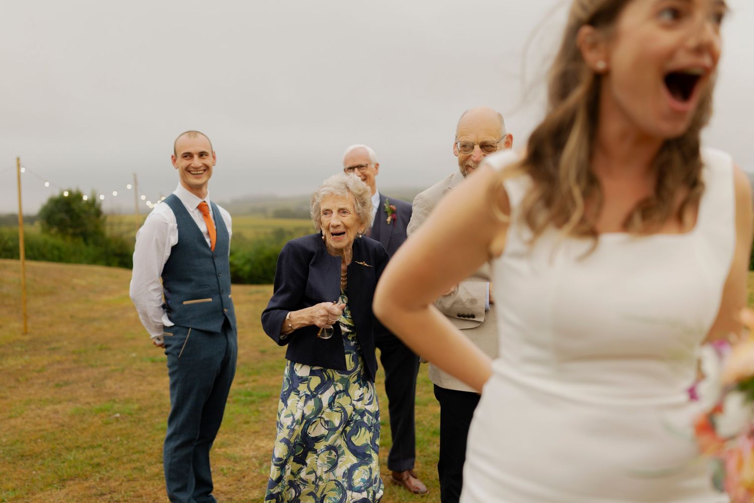 A collection of candid wedding photos showing joyful reactions and celebrations in an outdoor setting during golden hour.