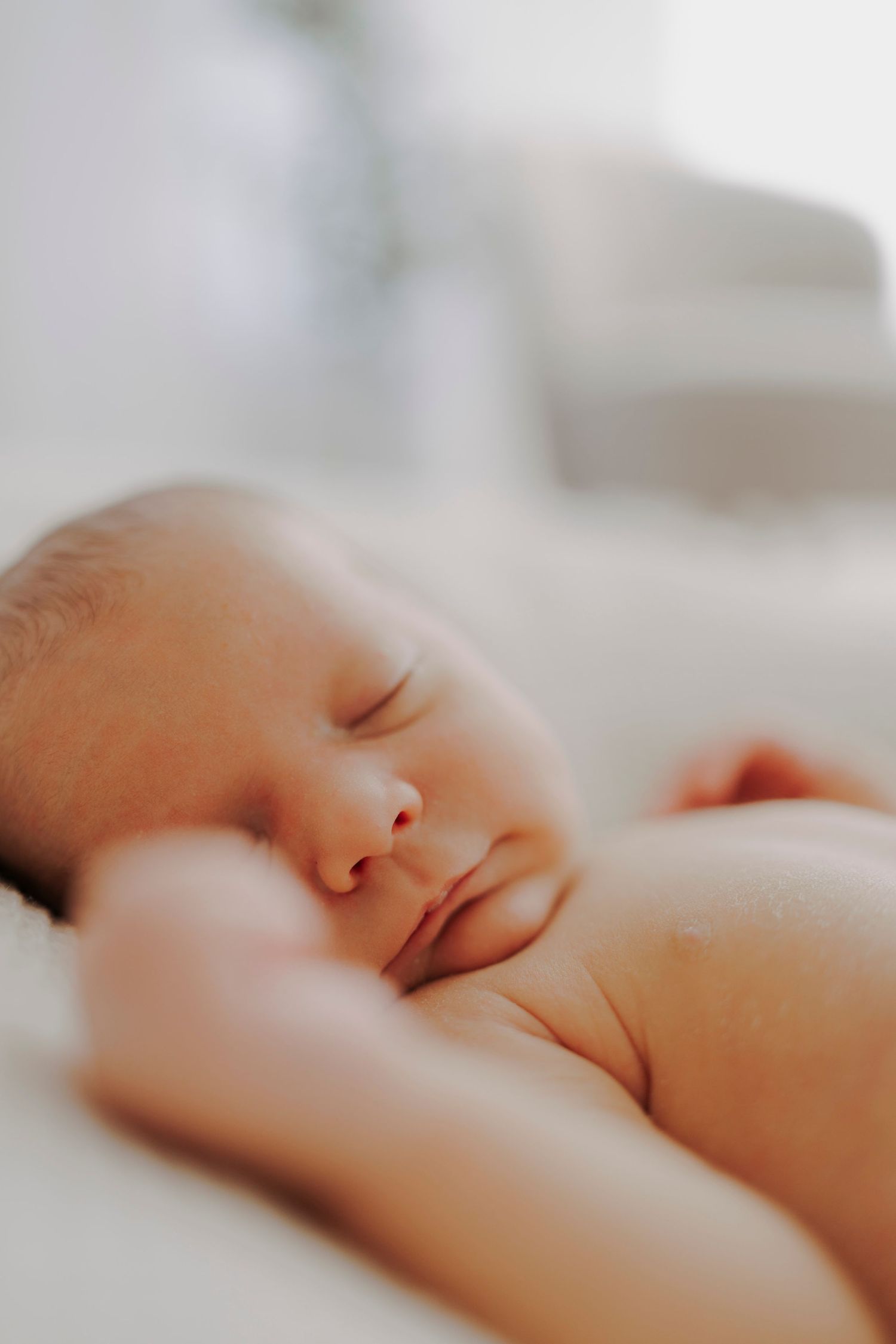Close-up of a peaceful sleeping newborn baby's face.