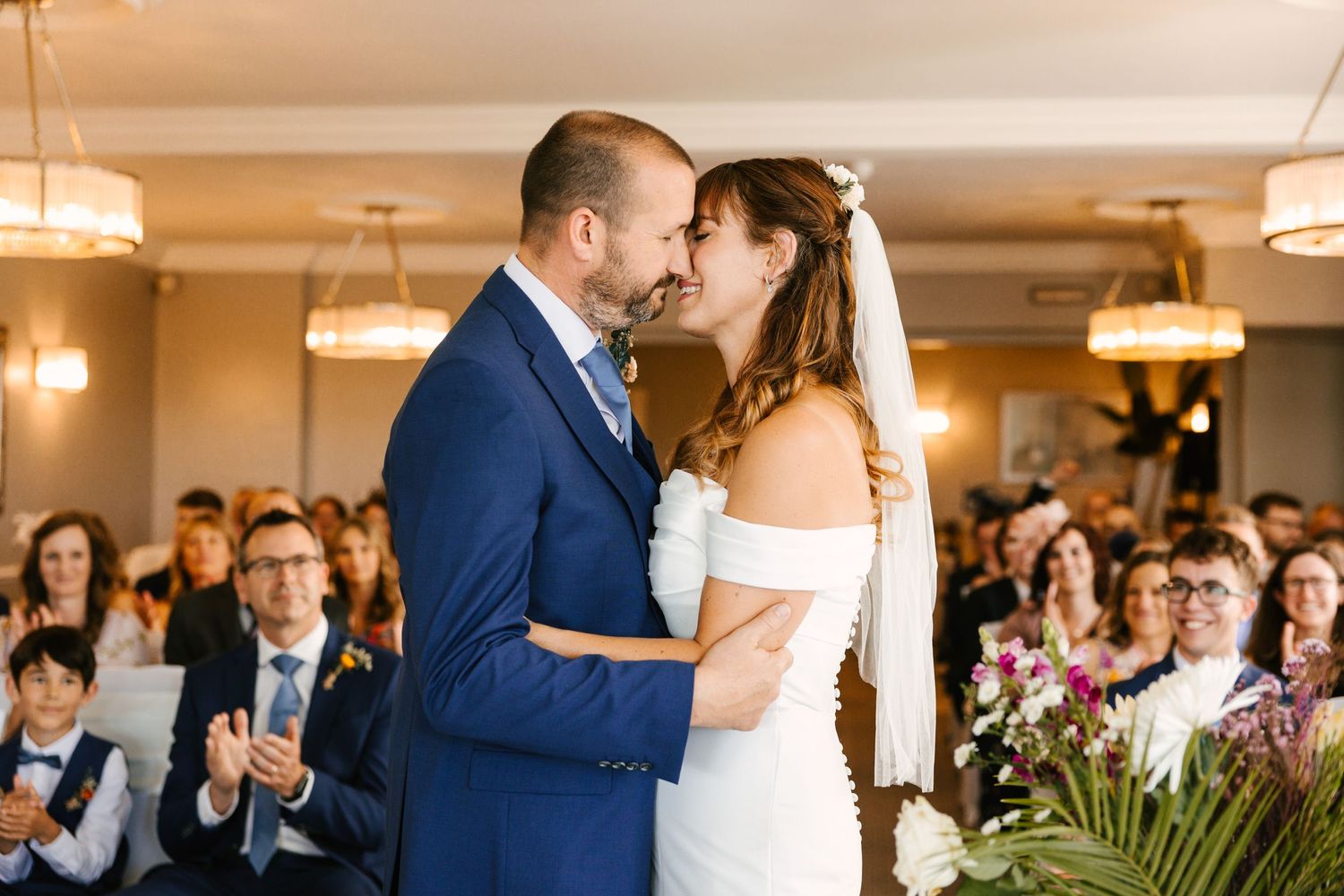 An intimate moment shared between a couple during their indoor wedding ceremony.