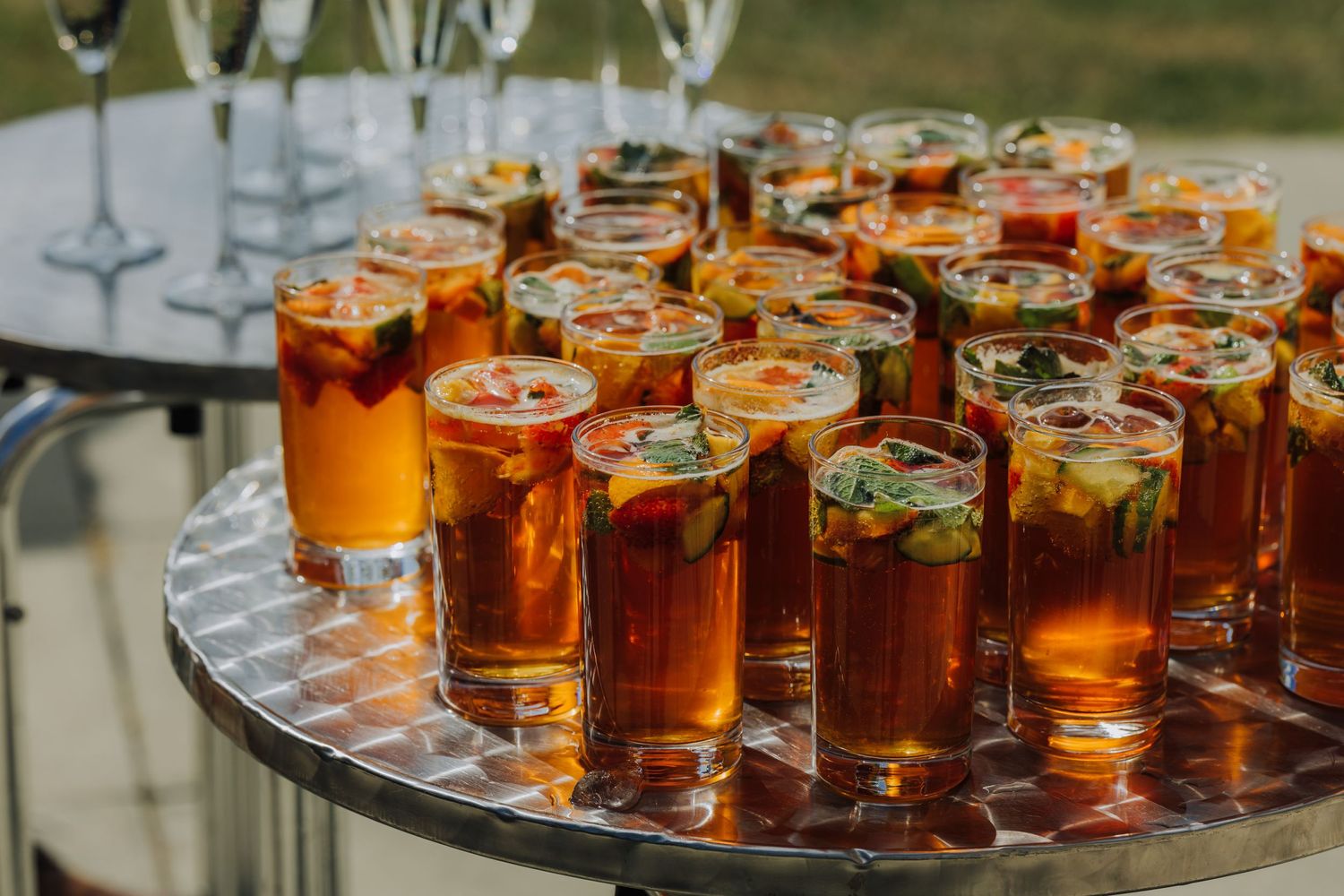 Artfully arranged wedding cocktails on a mirrored tray at an elegant reception.
