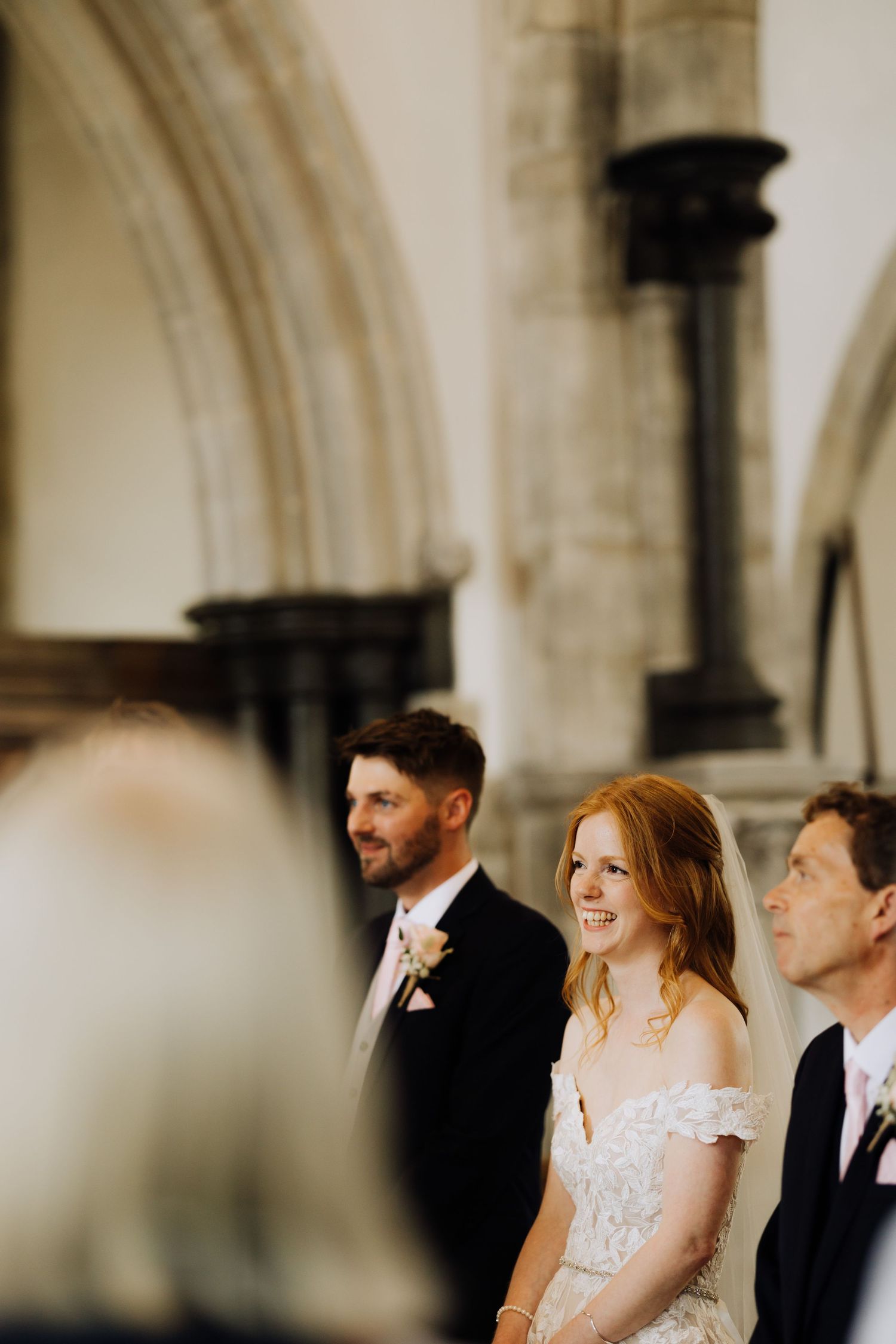 A joyous wedding ceremony moment captured in a beautiful church with stone archways.
