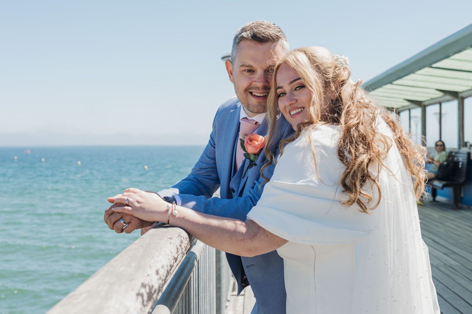 Couple enjoying a romantic moment on an oceanfront deck.