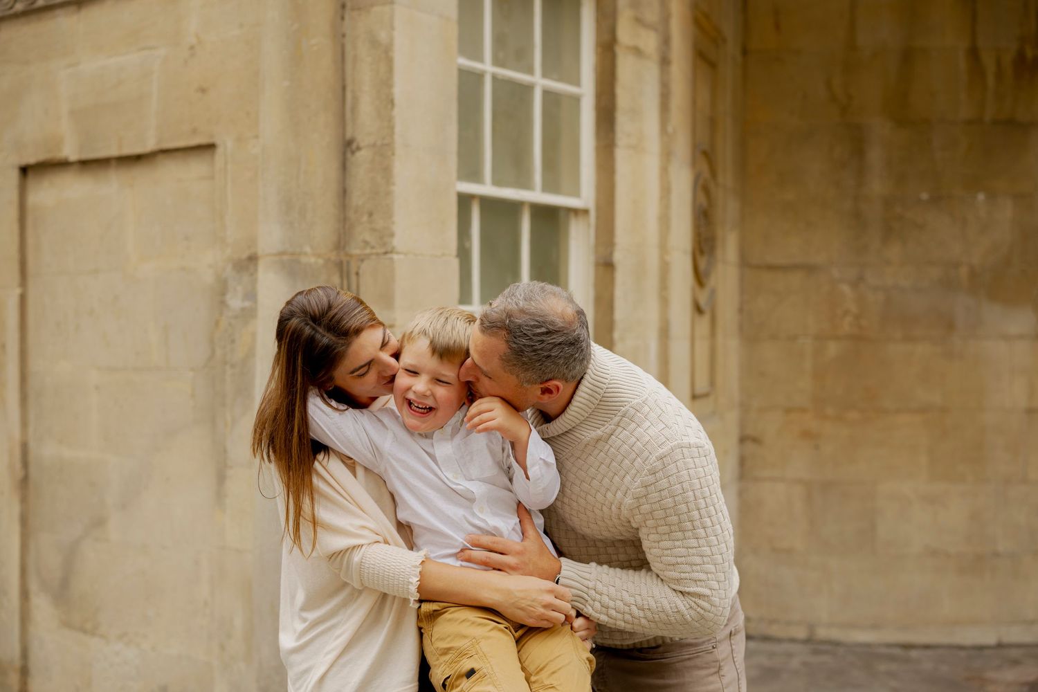 A couple shares a tender moment together on stone steps during an outdoor photo session.
