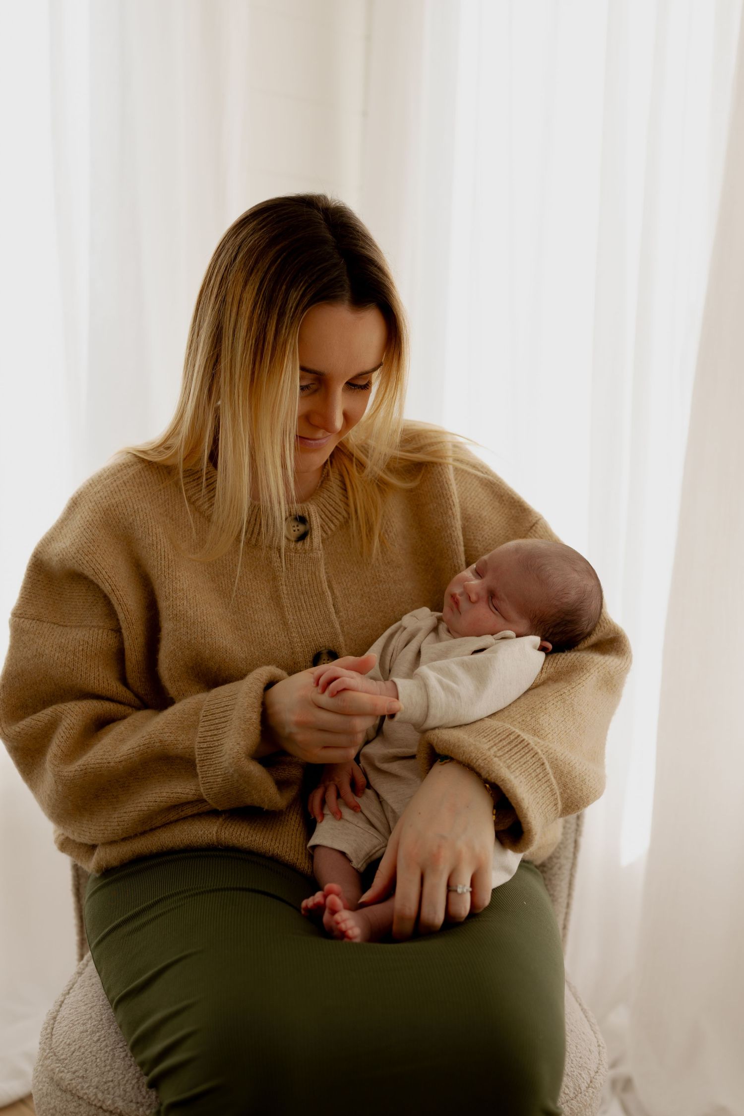 A series of four intimate photos showing tender moments between parent and newborn in soft natural light.