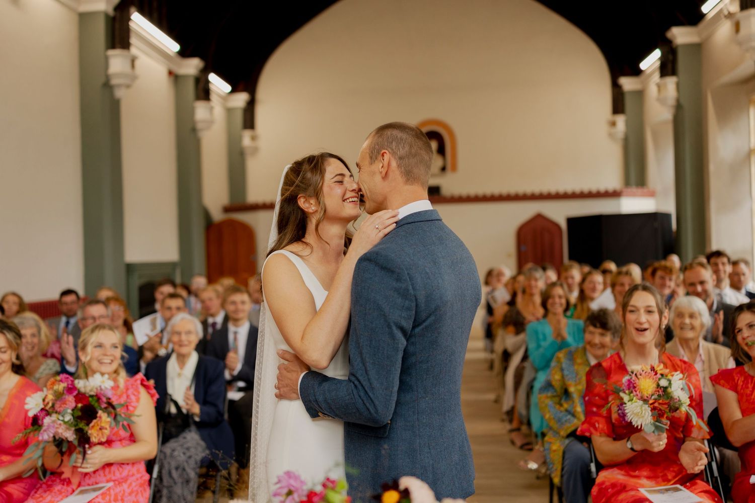 A romantic sequence shows newlyweds dancing together at their wedding reception with guests looking on in the background.