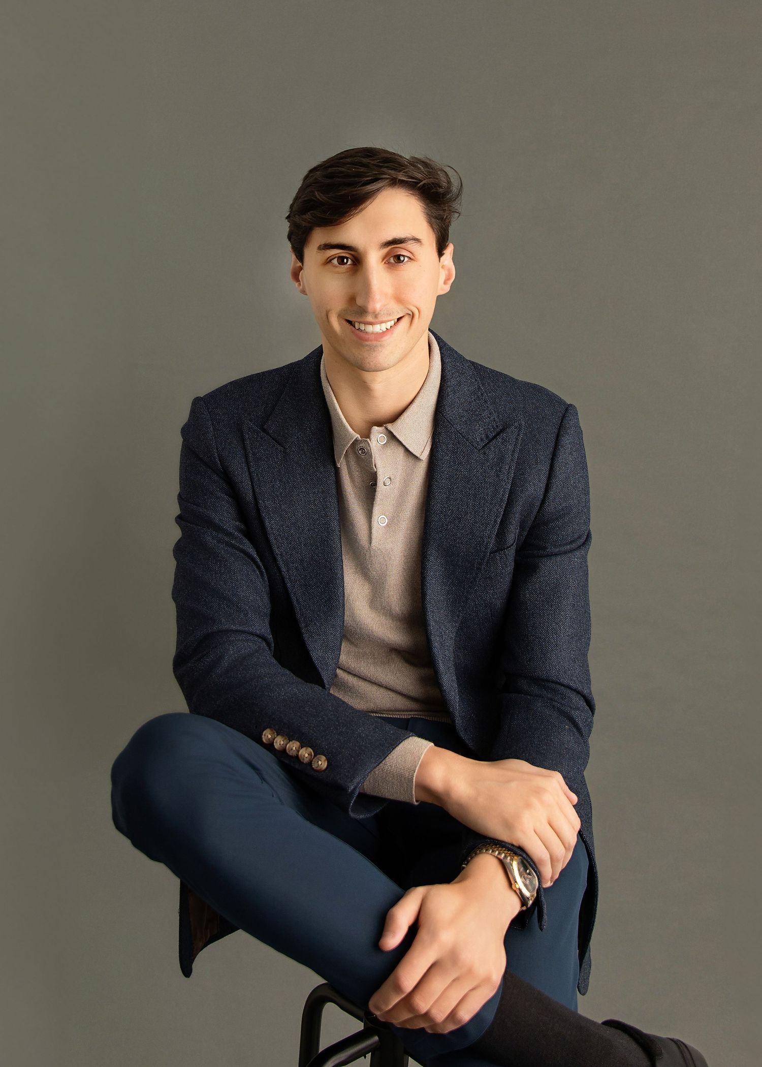 Professional studio photography showing various poses in dark business attire.