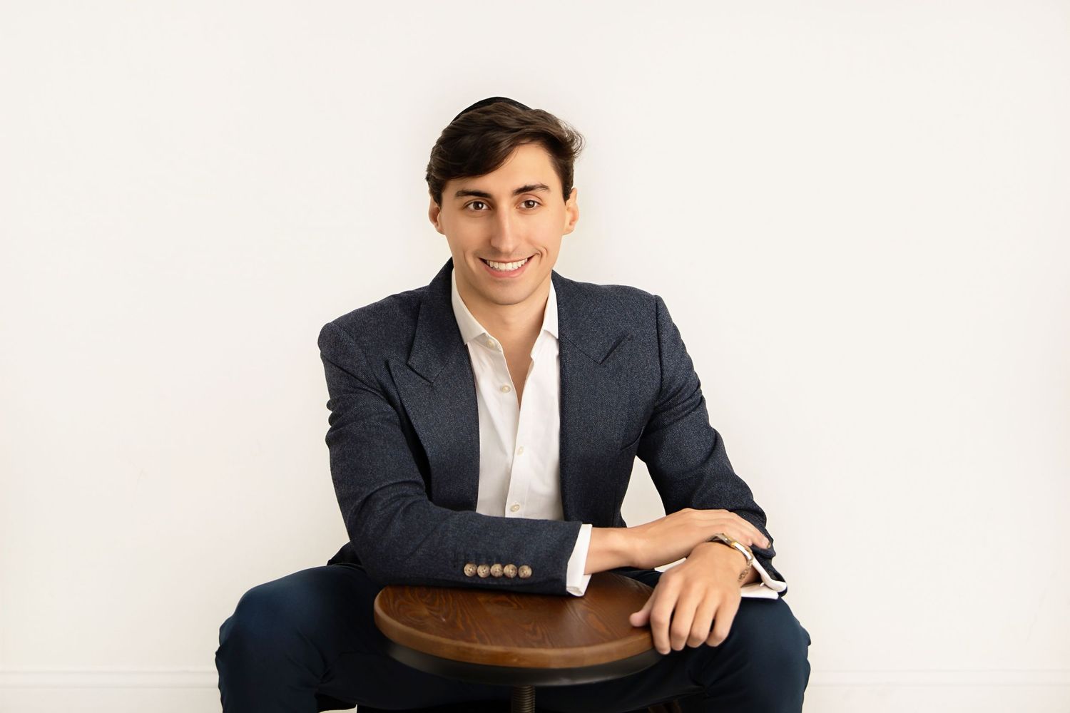 Business portrait series showing different seated poses in professional attire.