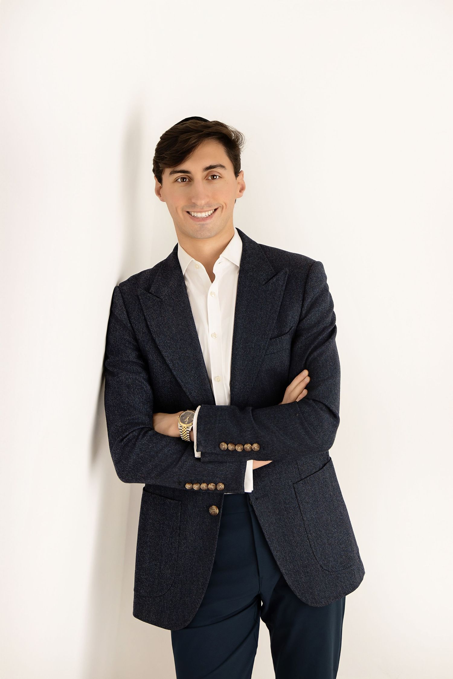 Professional headshots and poses in a navy blazer against a clean white background.
