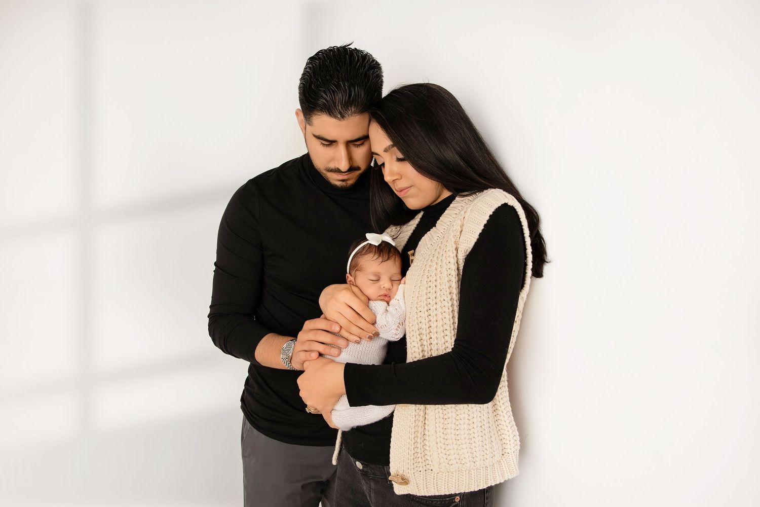 Mother gently cradling sleeping newborn during in-home lifestyle newborn photography in New Jersey