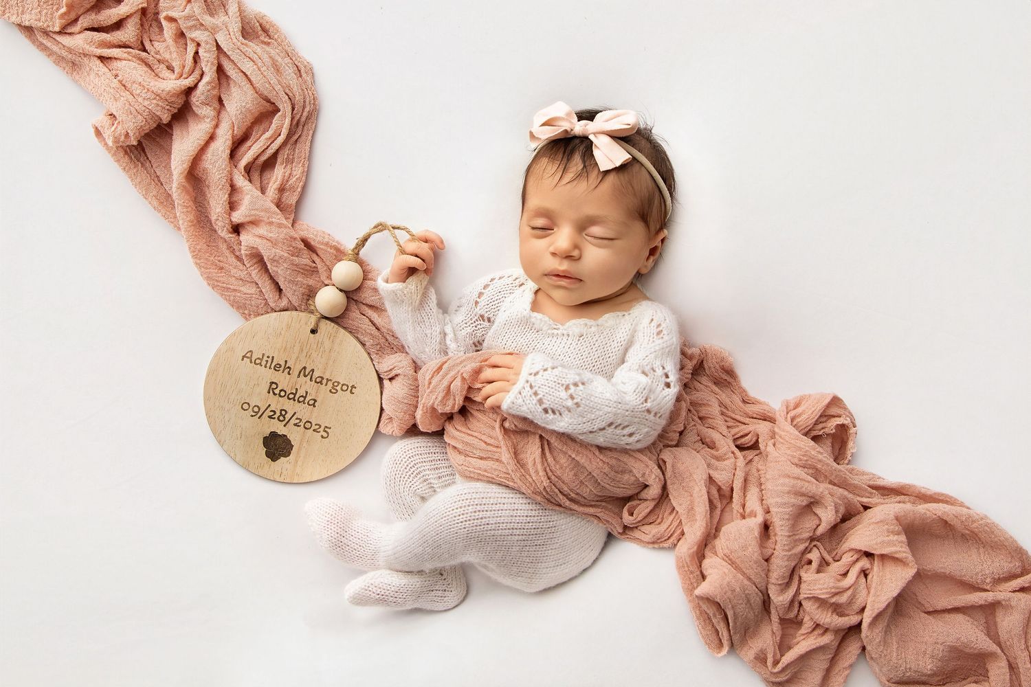 Newborn baby girl sleeping in soft wrap with bow headband Jackson NJ newborn photographer