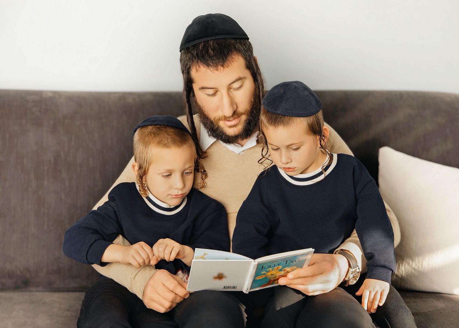 Father reading with two children captured in warm family pictures session