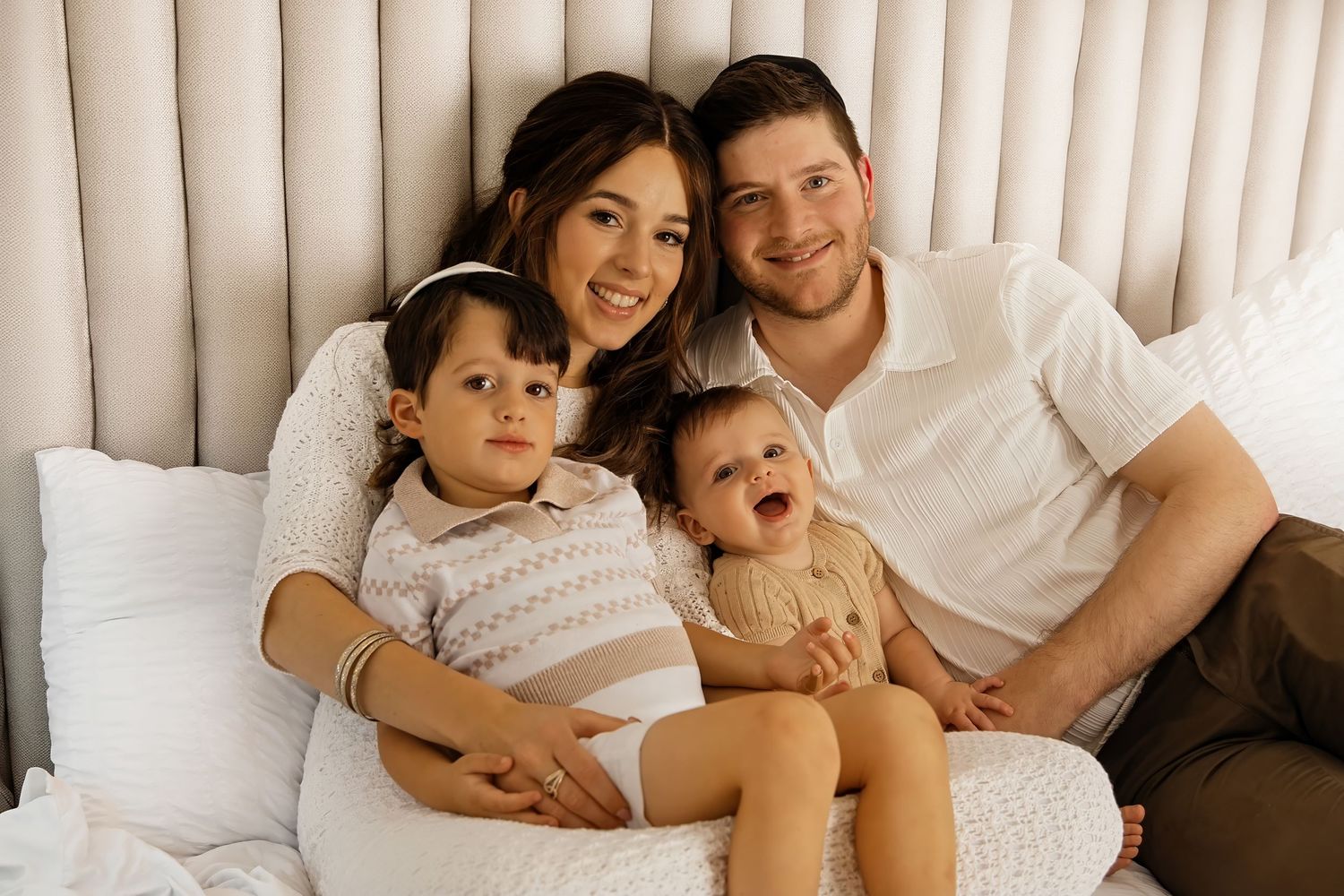 Happy family with two kids smiling together during cozy family photography session