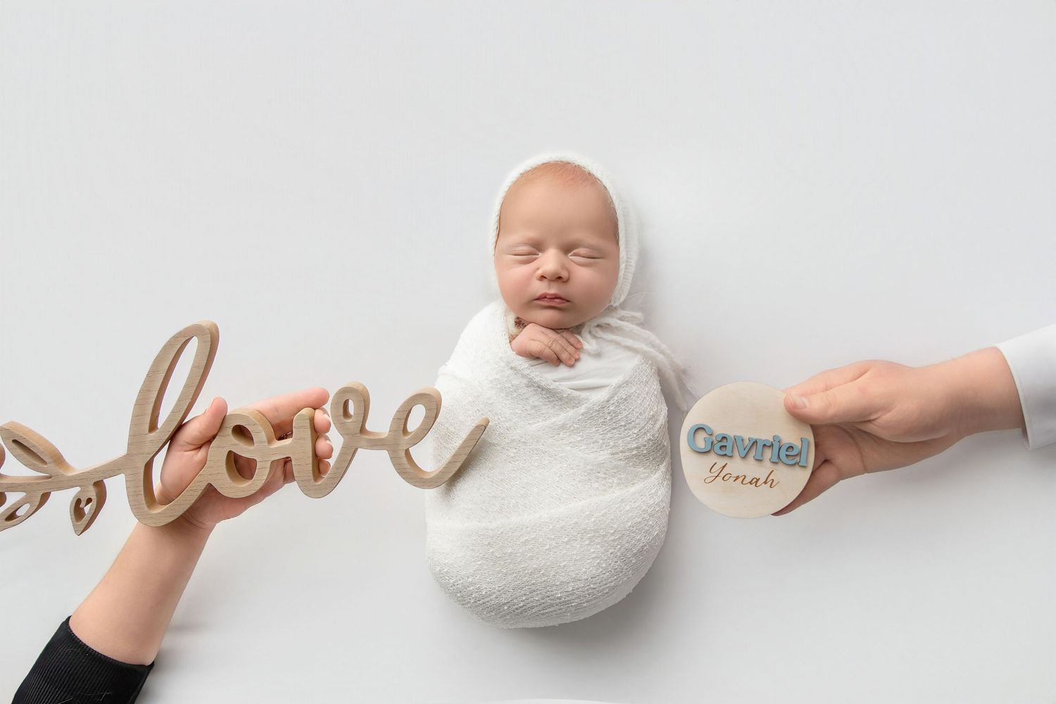 Sleeping baby wrapped in soft blanket styled for in home newborn photography session