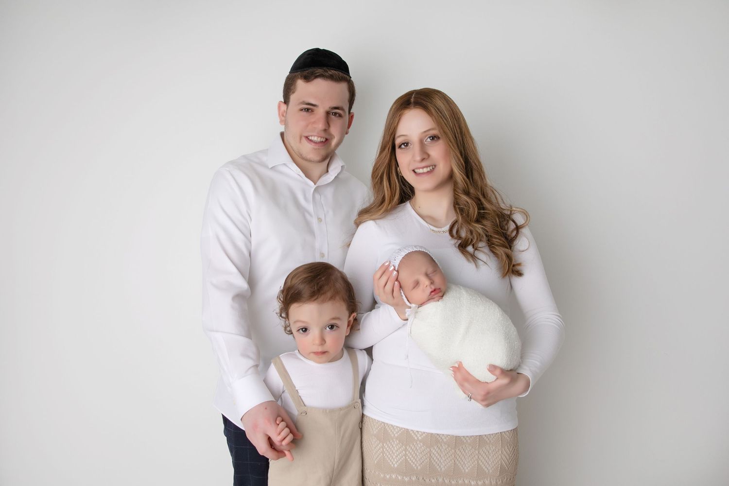 Family with newborn and toddler posing during family photography session