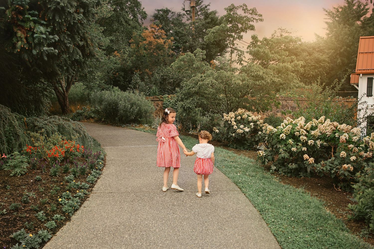Two sisters walking together in a garden
