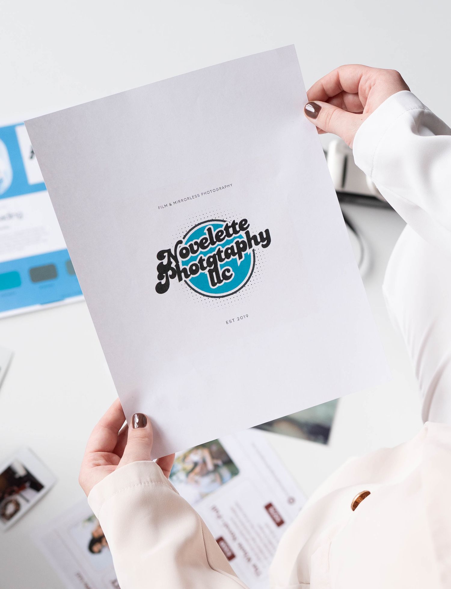 Collection of branded marketing materials and business cards spread on white surface.