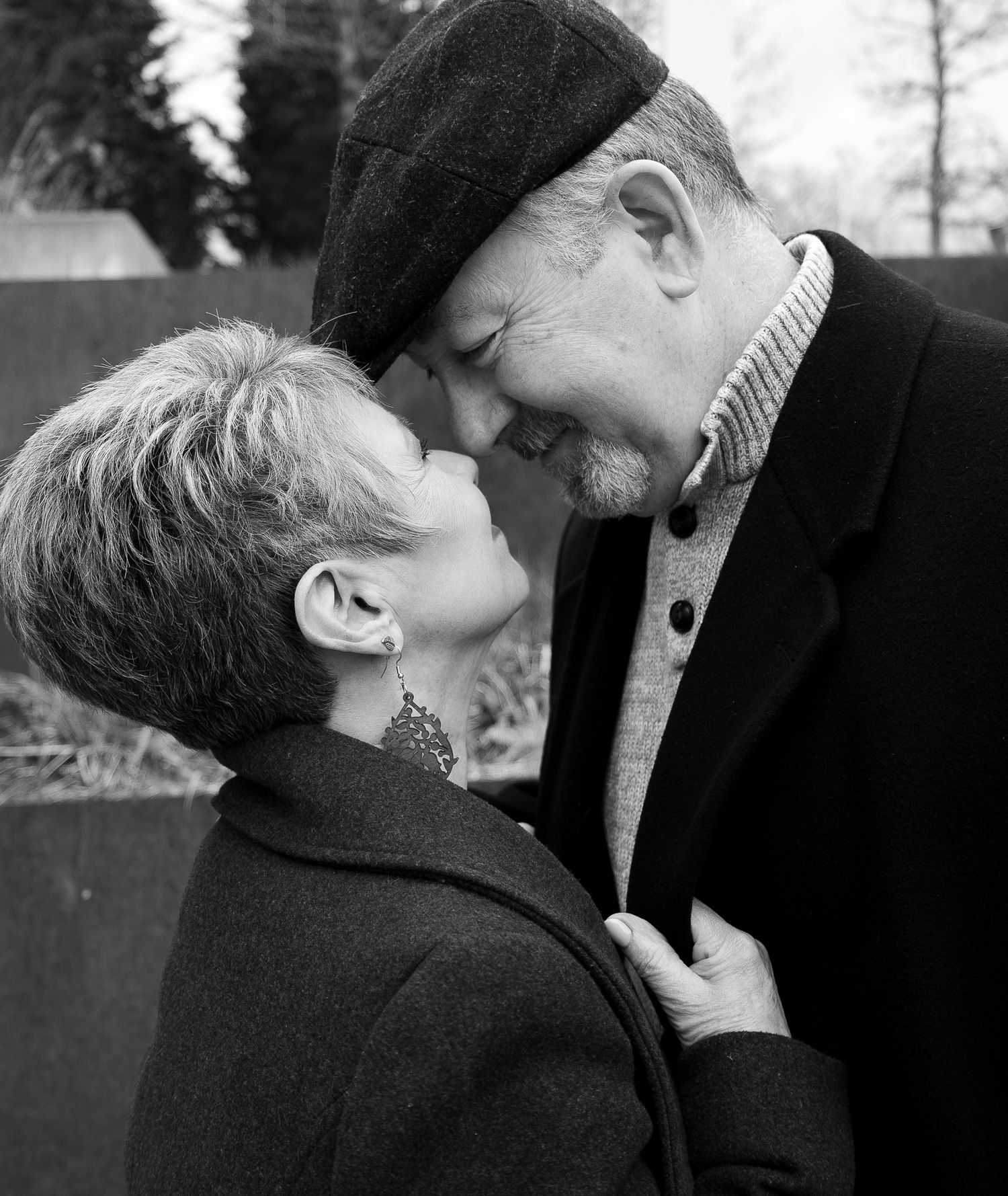 A series of black and white photos showing two people in an intimate embrace and kiss.
