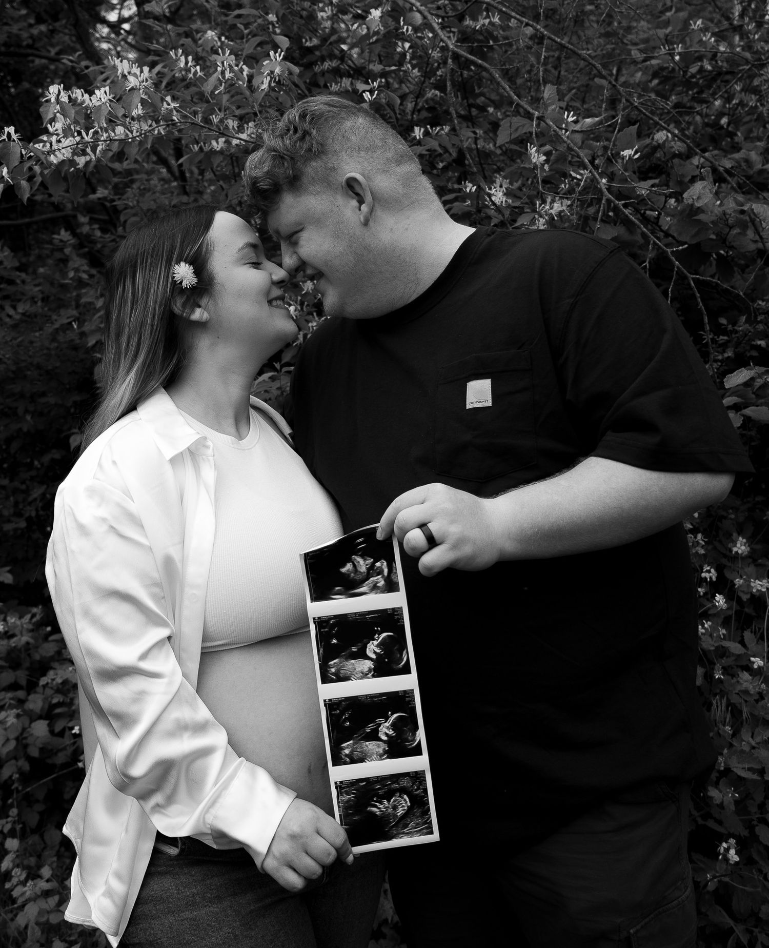 A photo of a couple announcing the joy of their pregnancy.