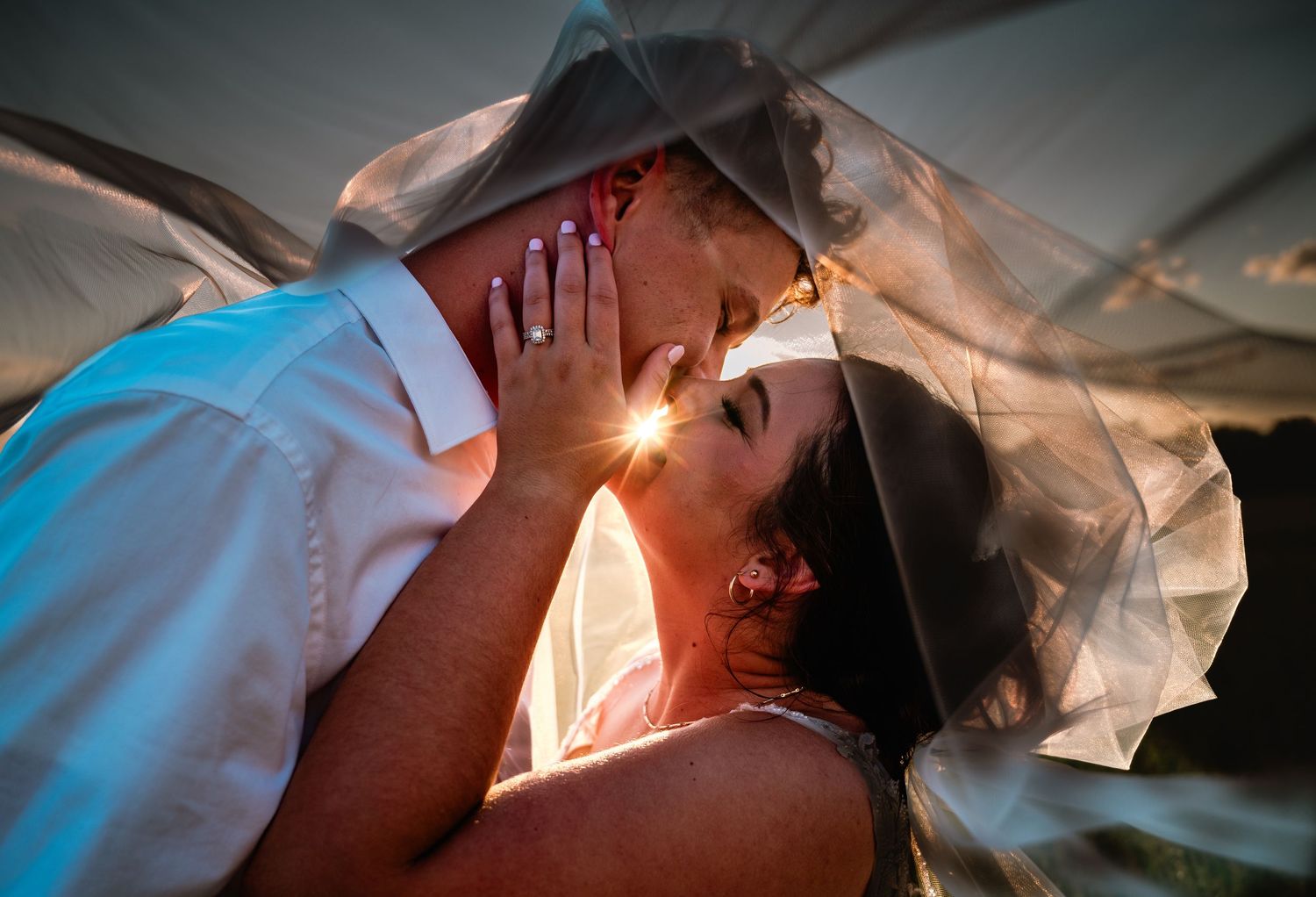 Bride and groom's joyful intimate moment during their first dance at a wedding reception.