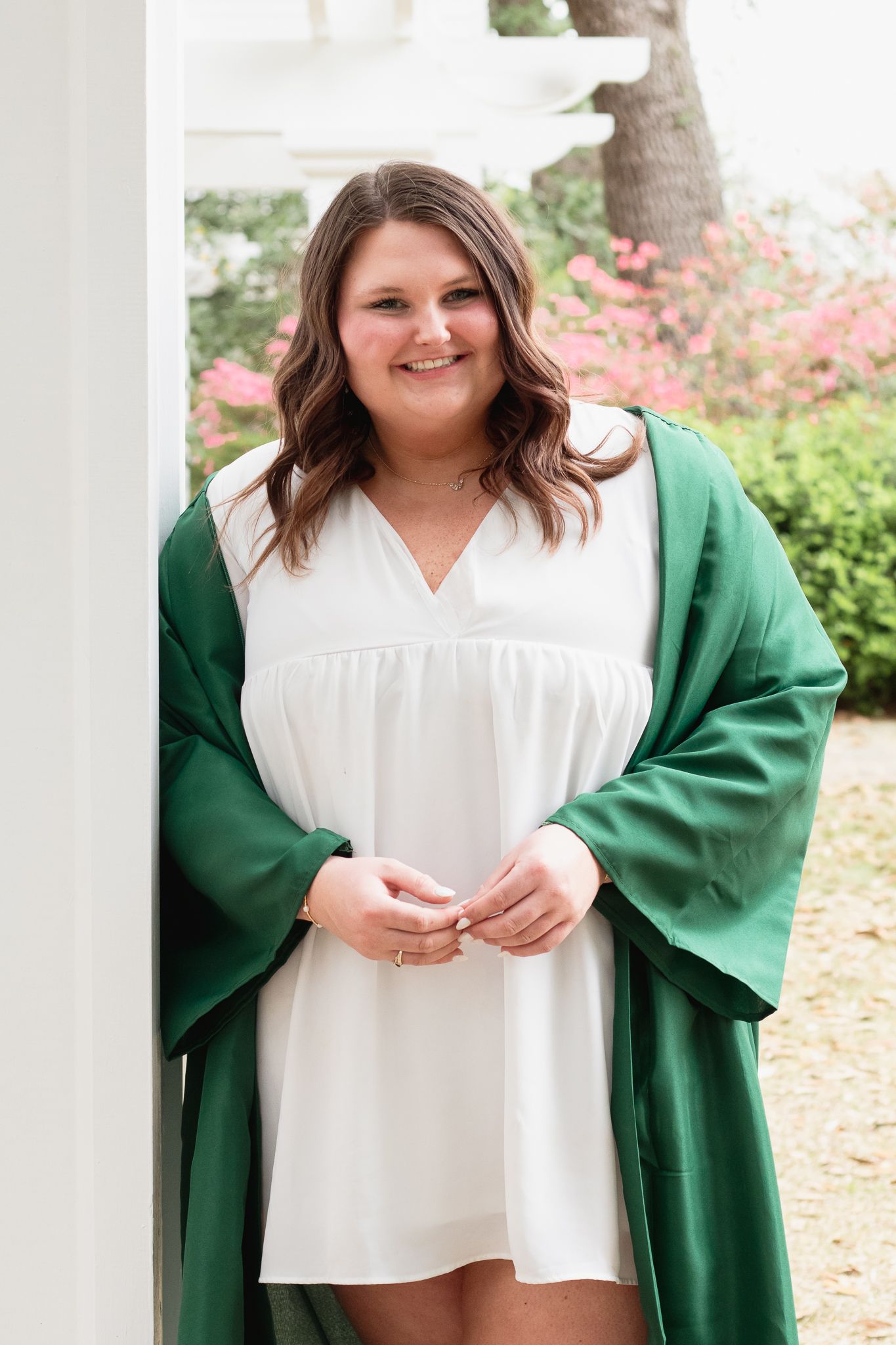 High school senior posing for a South Carolina photographer in Hartsville, SC for their senior pictures graduation portraits. garden candid