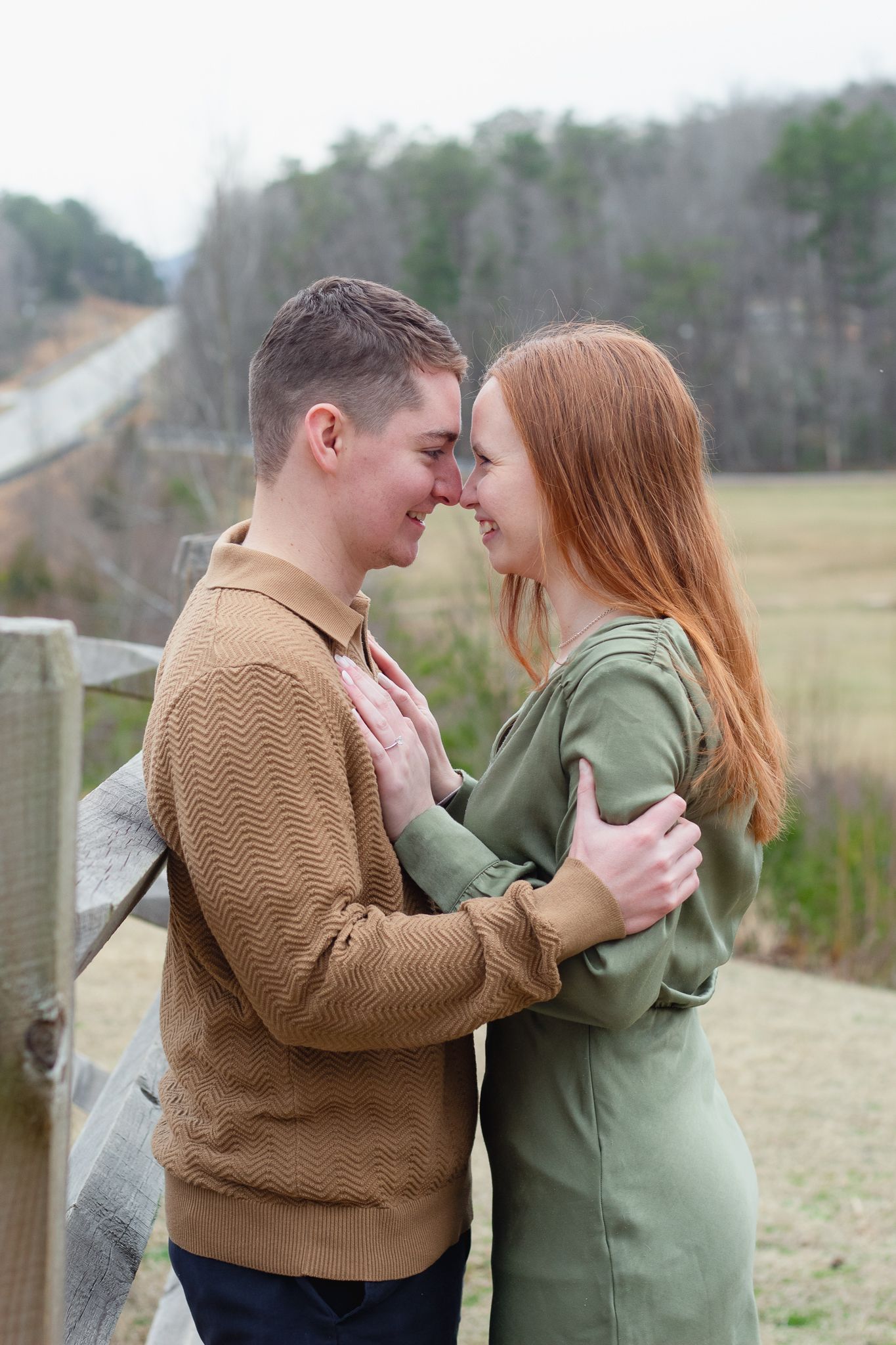 Couple posing for South Carolina photographer at Table Rock park Greenville engagement portraits photoshoot. Candid true to color upstate sc