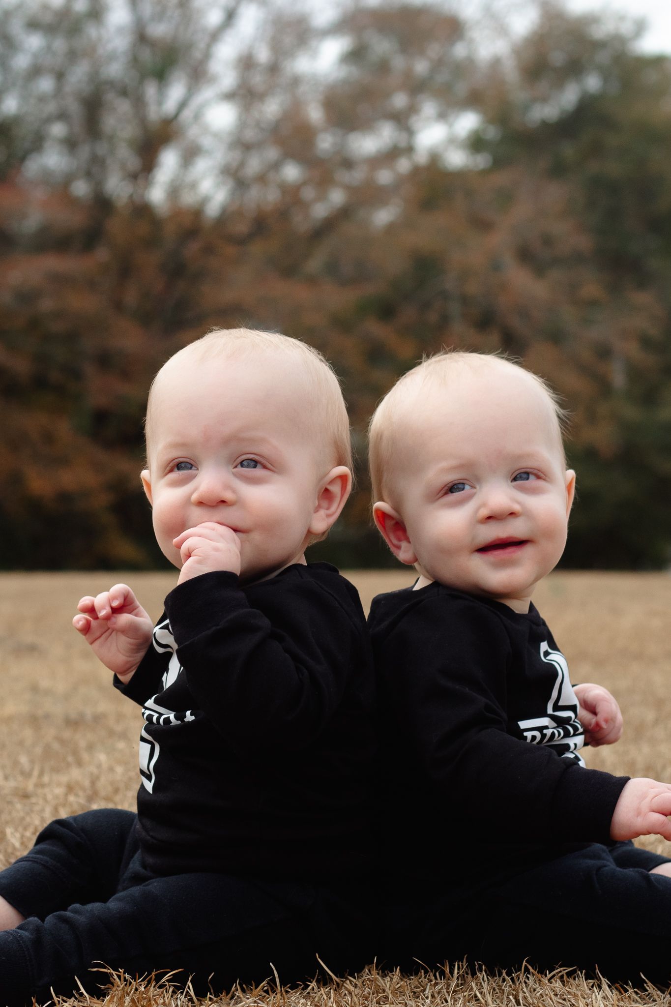 Twin babies posing for South Carolina photographer upstate SC family portraits photography pictures. True to color candid children