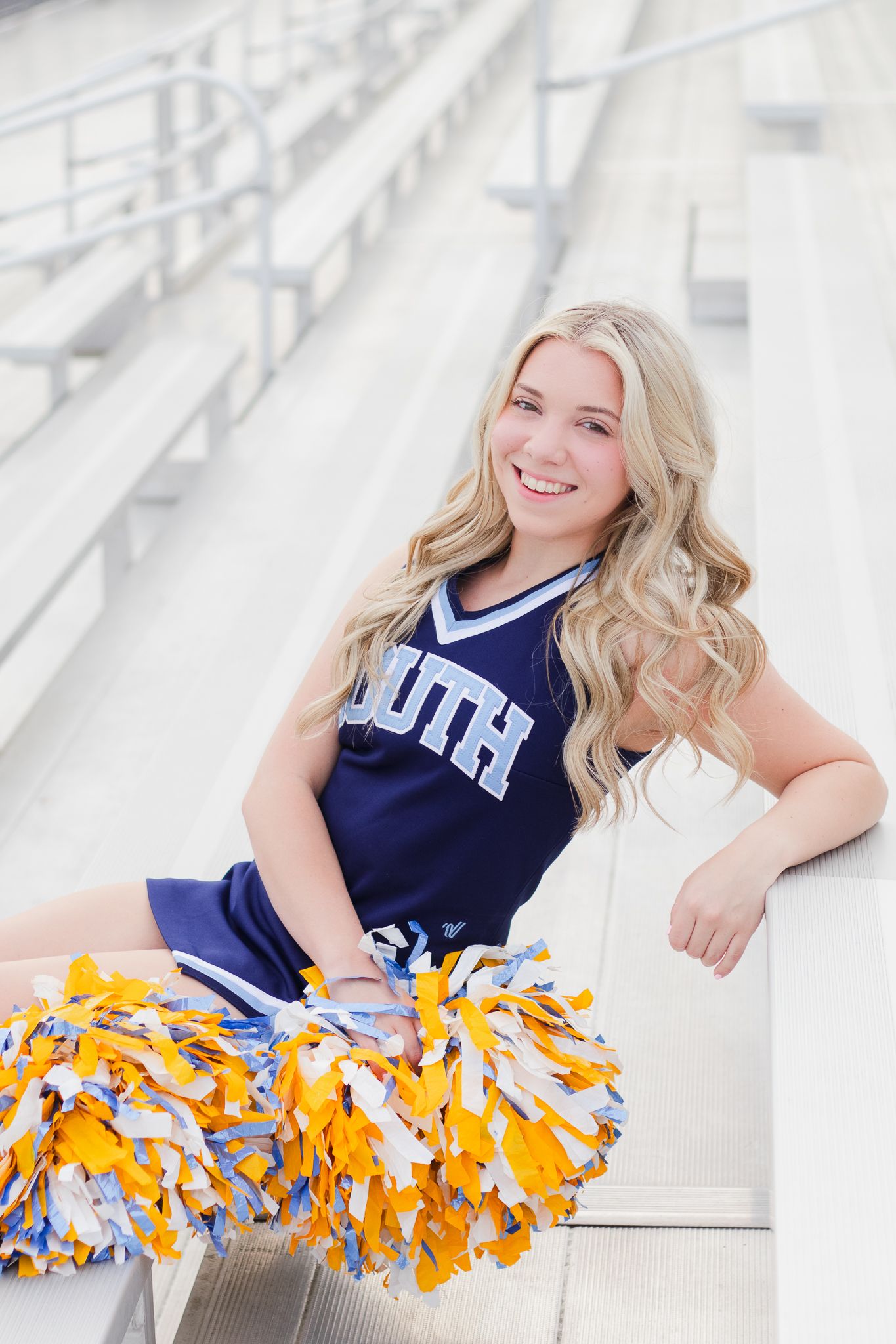 High school senior cheerleader posing for South Carolina photographer in Florence, SC for their senior pictures graduation portraits. Candid