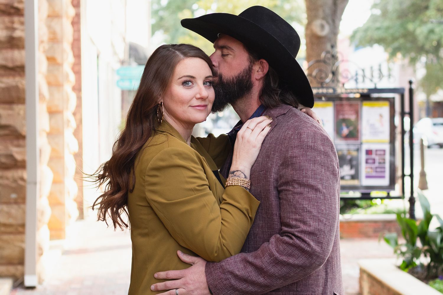 Couple posing for South Carolina photographer at downtown Sumter engagement portraits photoshoot. Candid true to color sc country