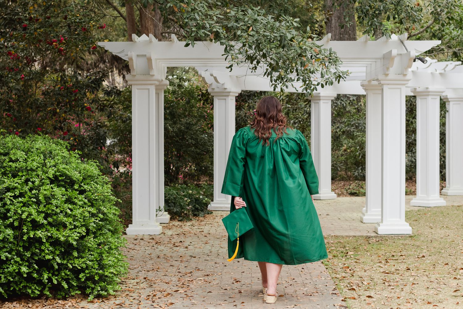 High school senior posing for a South Carolina photographer in Hartsville, SC for their senior pictures graduation portraits. garden candid