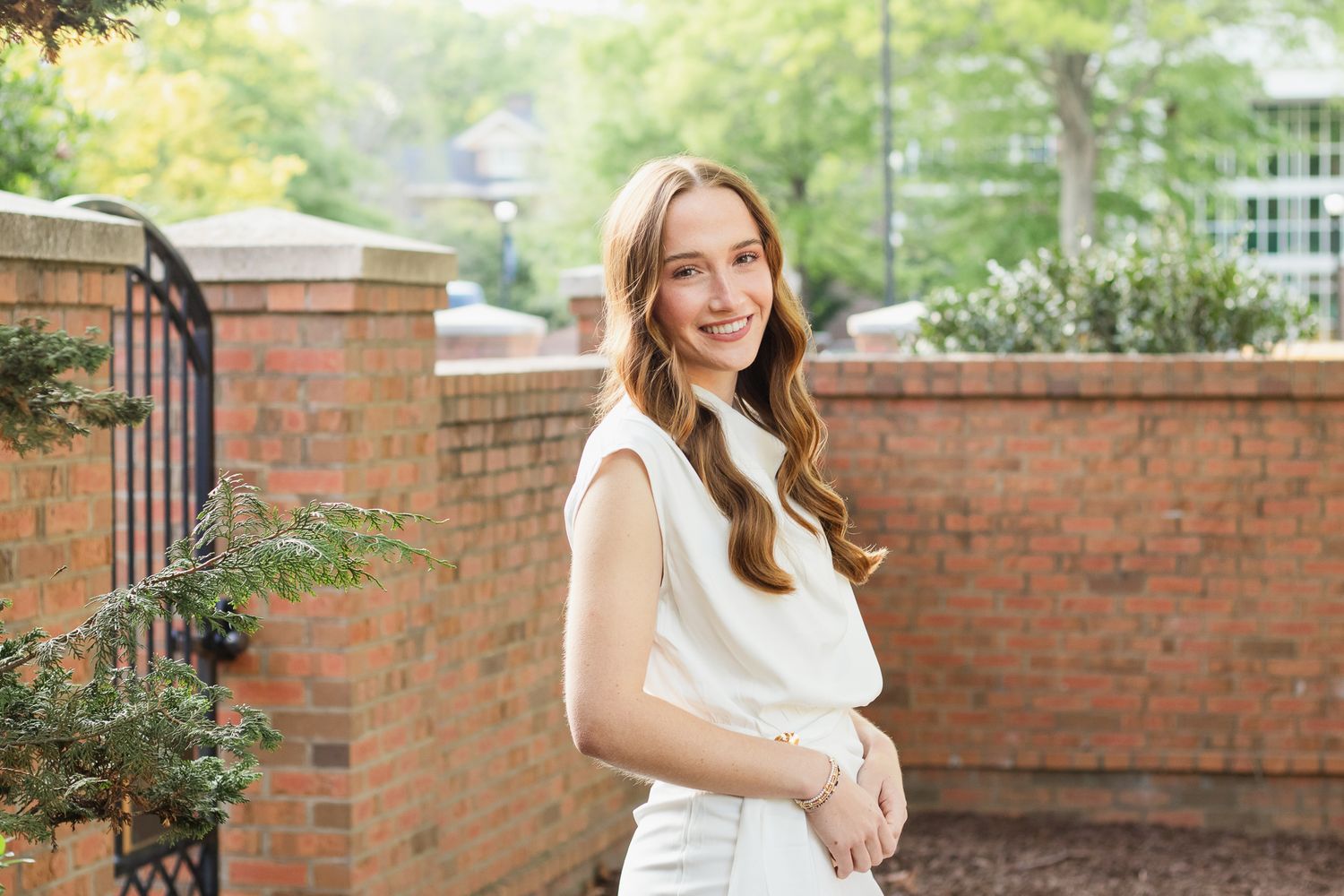 High school senior posing for a South Carolina photographer in Hartsville, SC for their senior pictures graduation portraits. garden candid