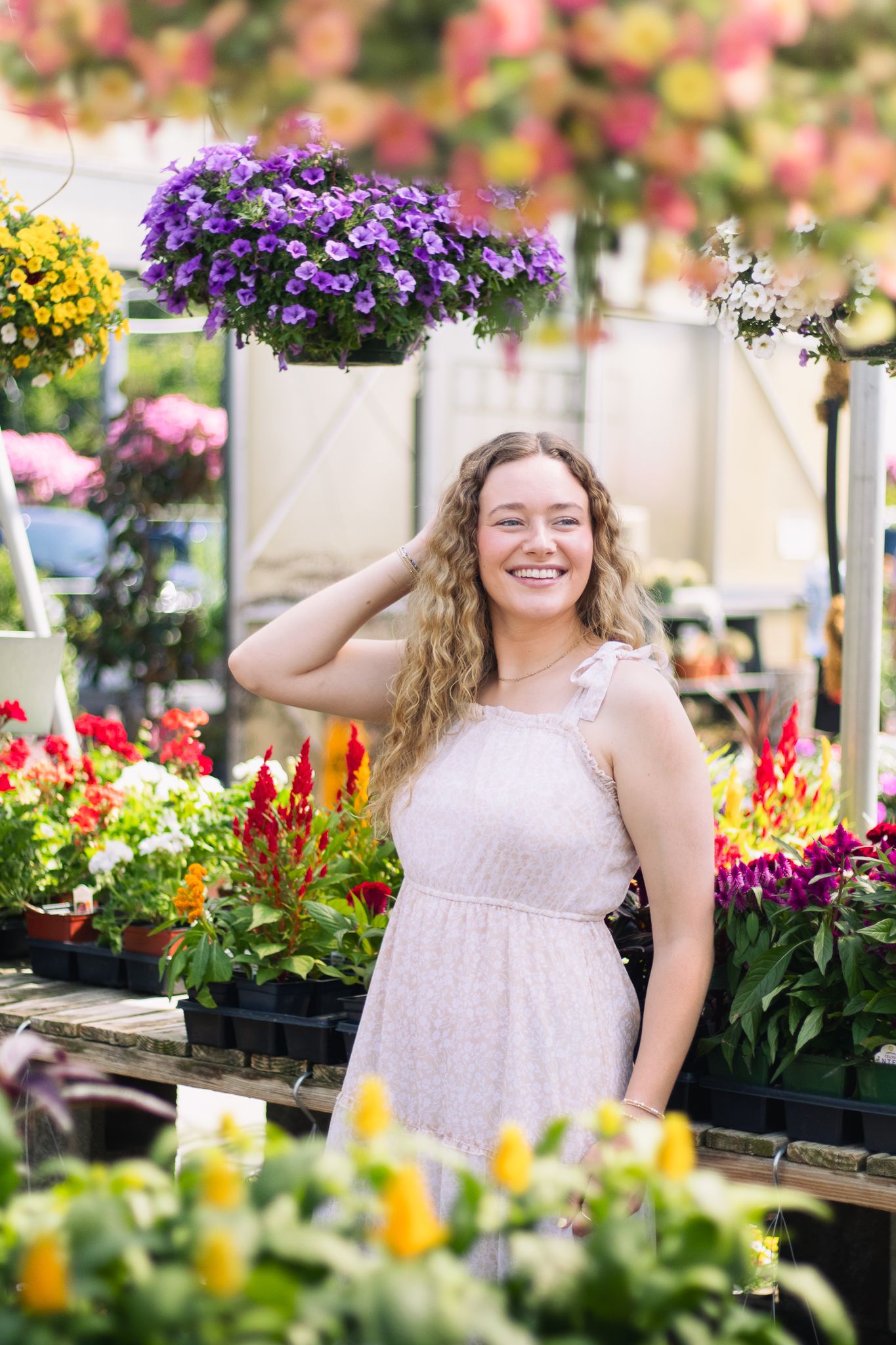 Blonde young adult posing for a South Carolina photographer in Florence, SC at a greenhouse photoshoot portraits. Candid and true-to-color