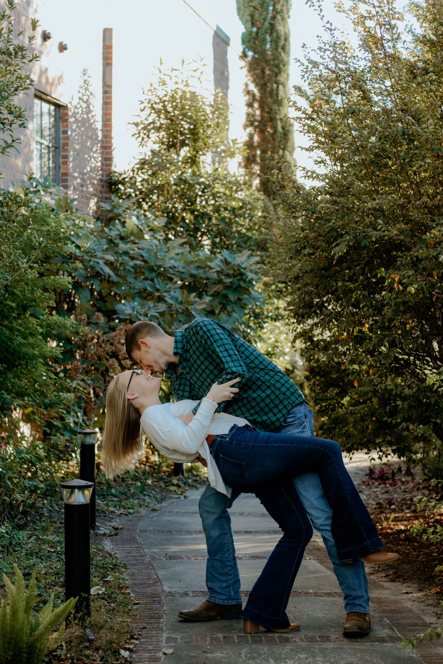 Couple posing for South Carolina photographer at downtown Lake City engagement portraits photoshoot. Candid true to color sc country
