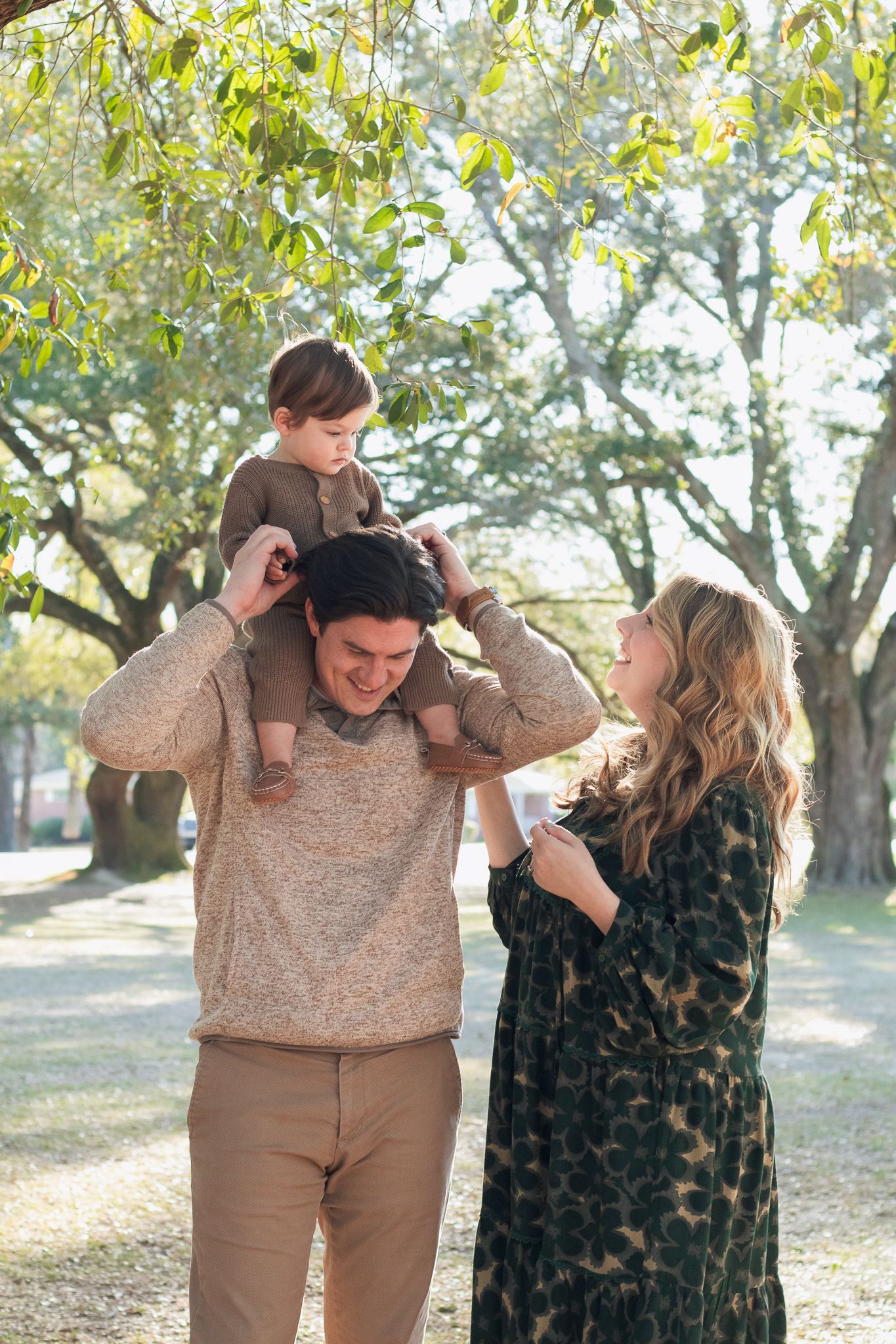 Family posing for South Carolina photographer in Florence SC engagement portraits photoshoot. Candid true to color family pictures children