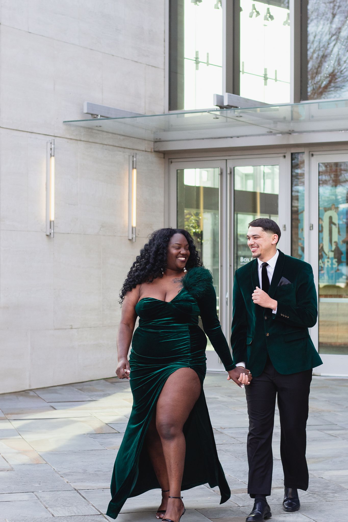 Couple posing for South Carolina photographer at downtown Greenville engagement portraits photoshoot. Candid true to color upstate sc formal