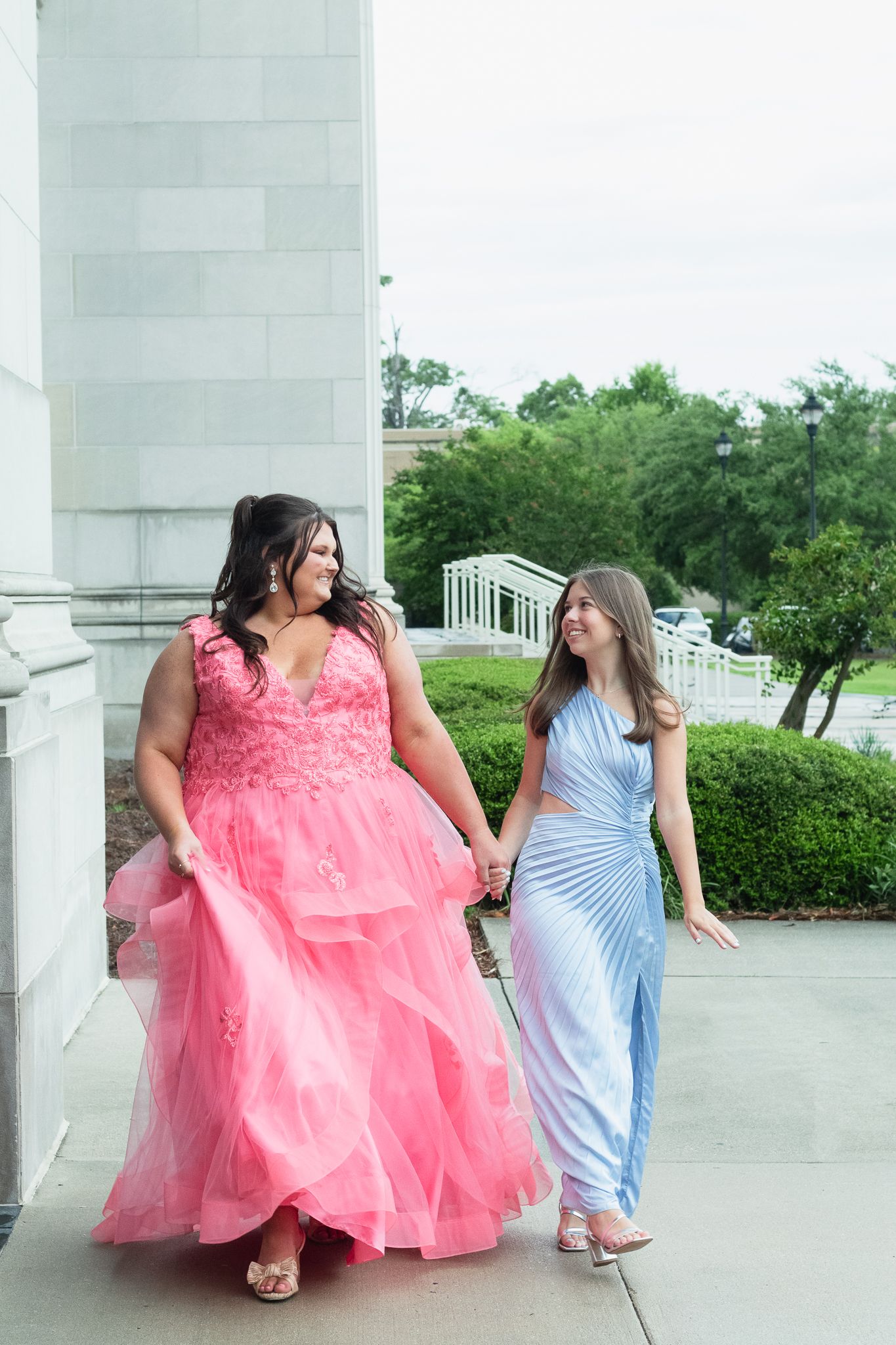 Two best friends posing for a South Carolina photographer in Florence, SC for their senior prom pictures portraits.