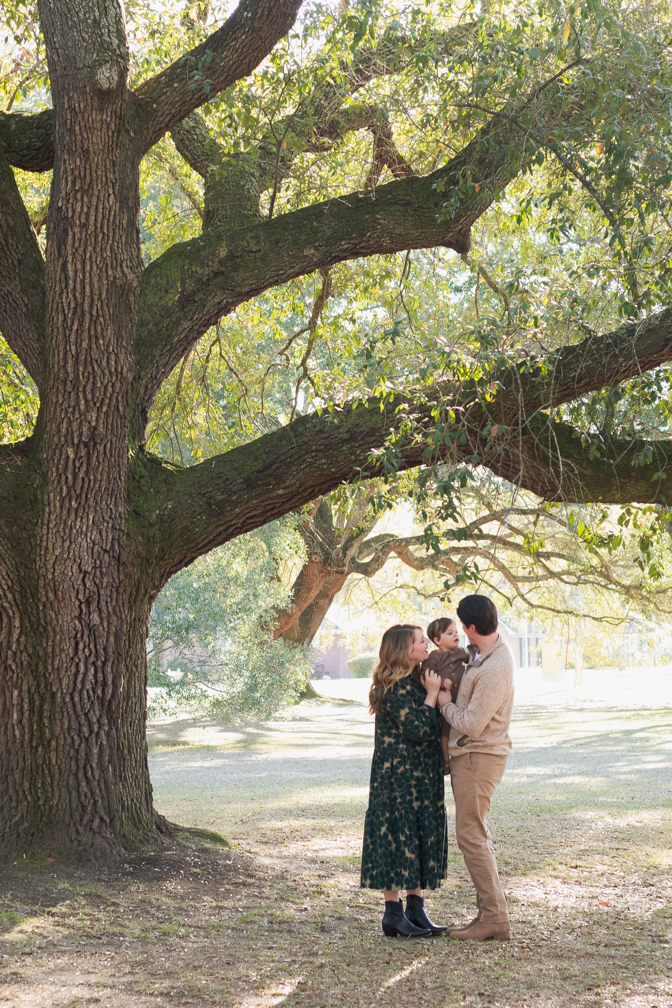 Family posing for South Carolina photographer in Florence SC engagement portraits photoshoot. Candid true to color family pictures children