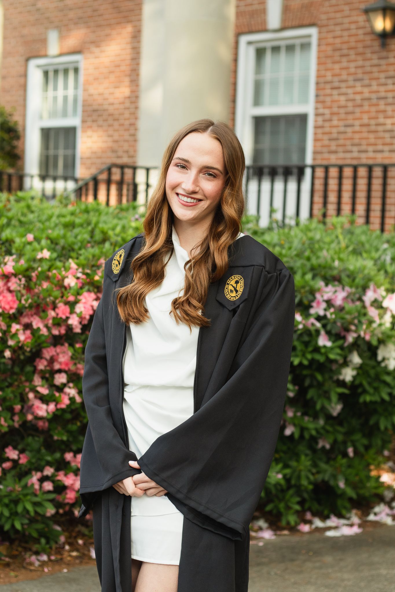 High school senior posing for a South Carolina photographer in Hartsville, SC for their senior pictures graduation portraits. garden candid