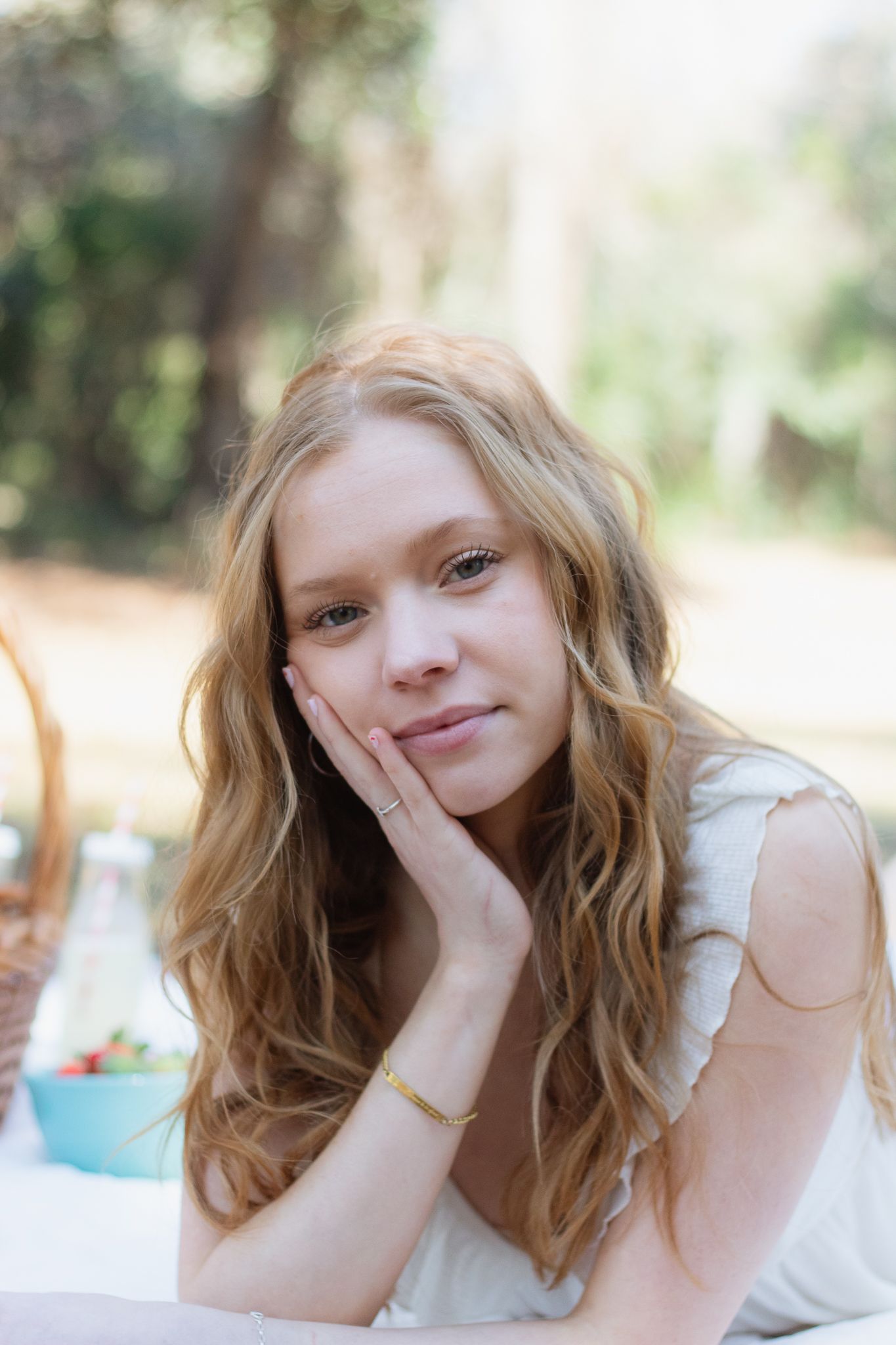 Blonde woman posing for portraits for South Carolina photographer picnic themed photoshoot. Spring photography candid true to color minis