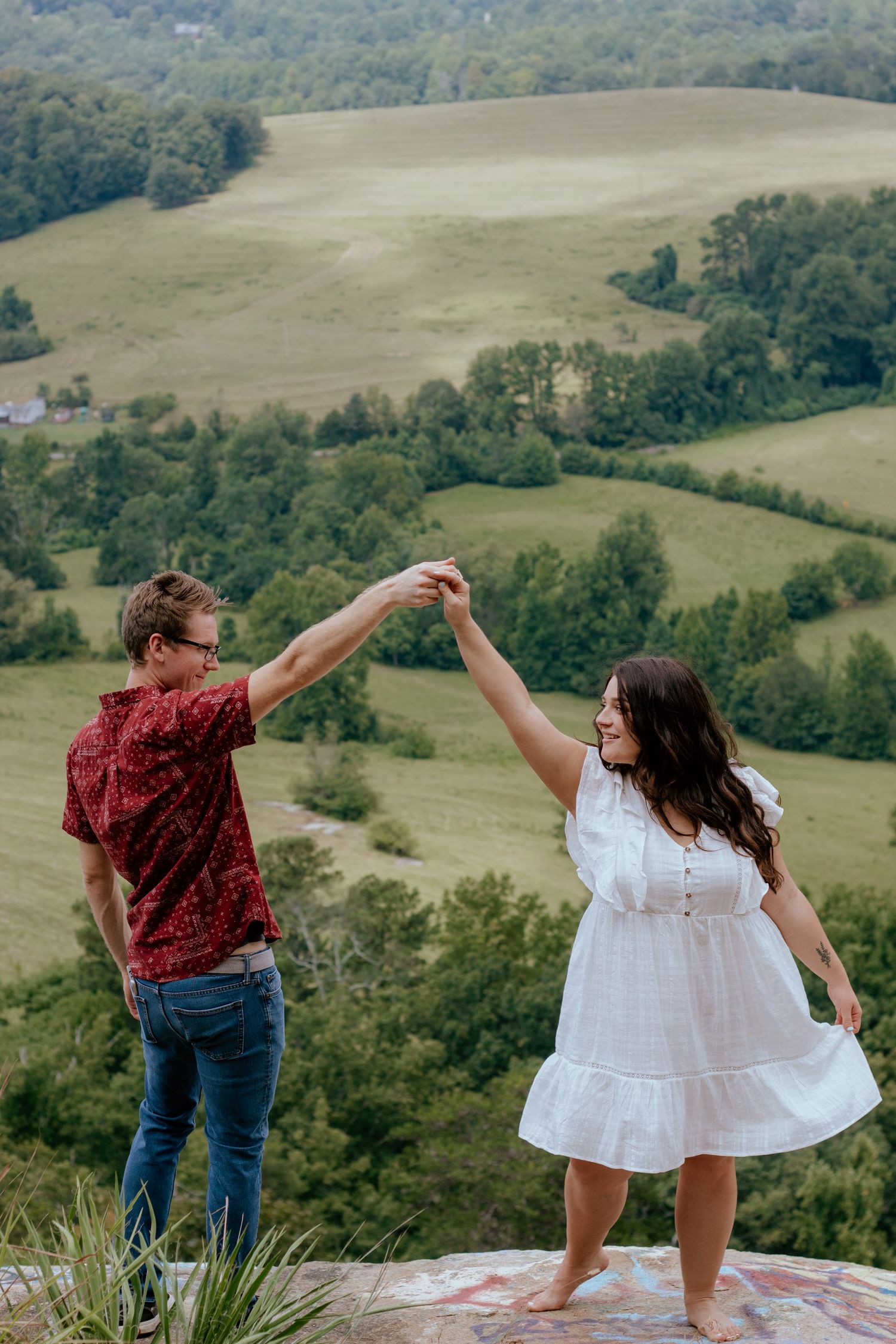Couple posing for South Carolina photographer at Bald Rock Greenville engagement portraits photoshoot. Candid true to color upstate sc