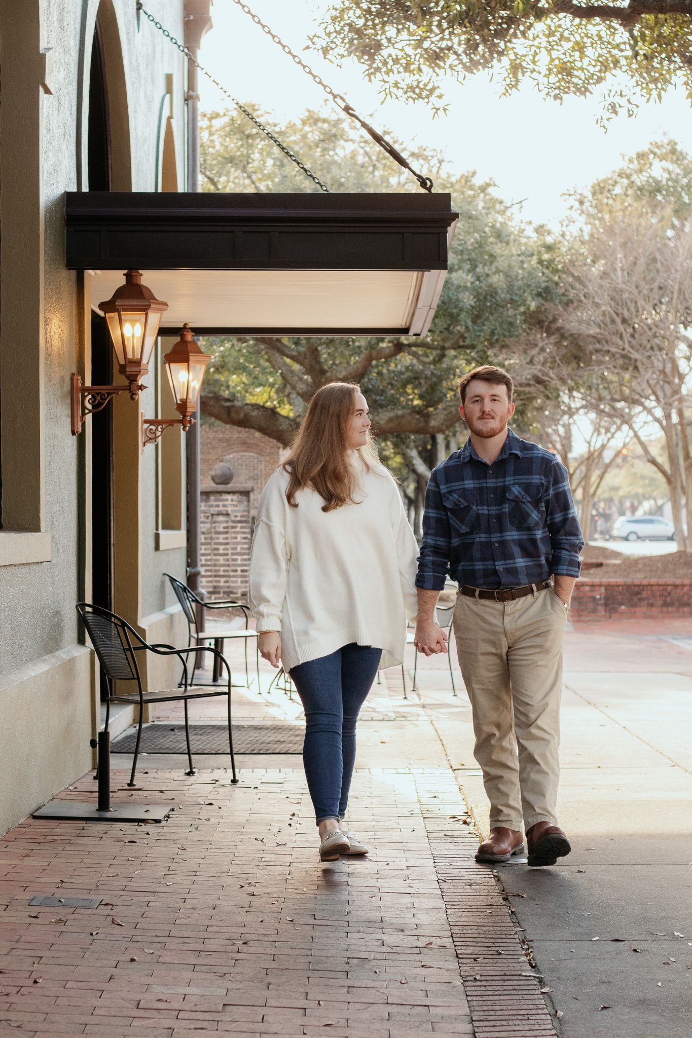Couple posing for South Carolina photographer in downtown Hartsville SC in Florence engagement portraits photoshoot. Candid true to color