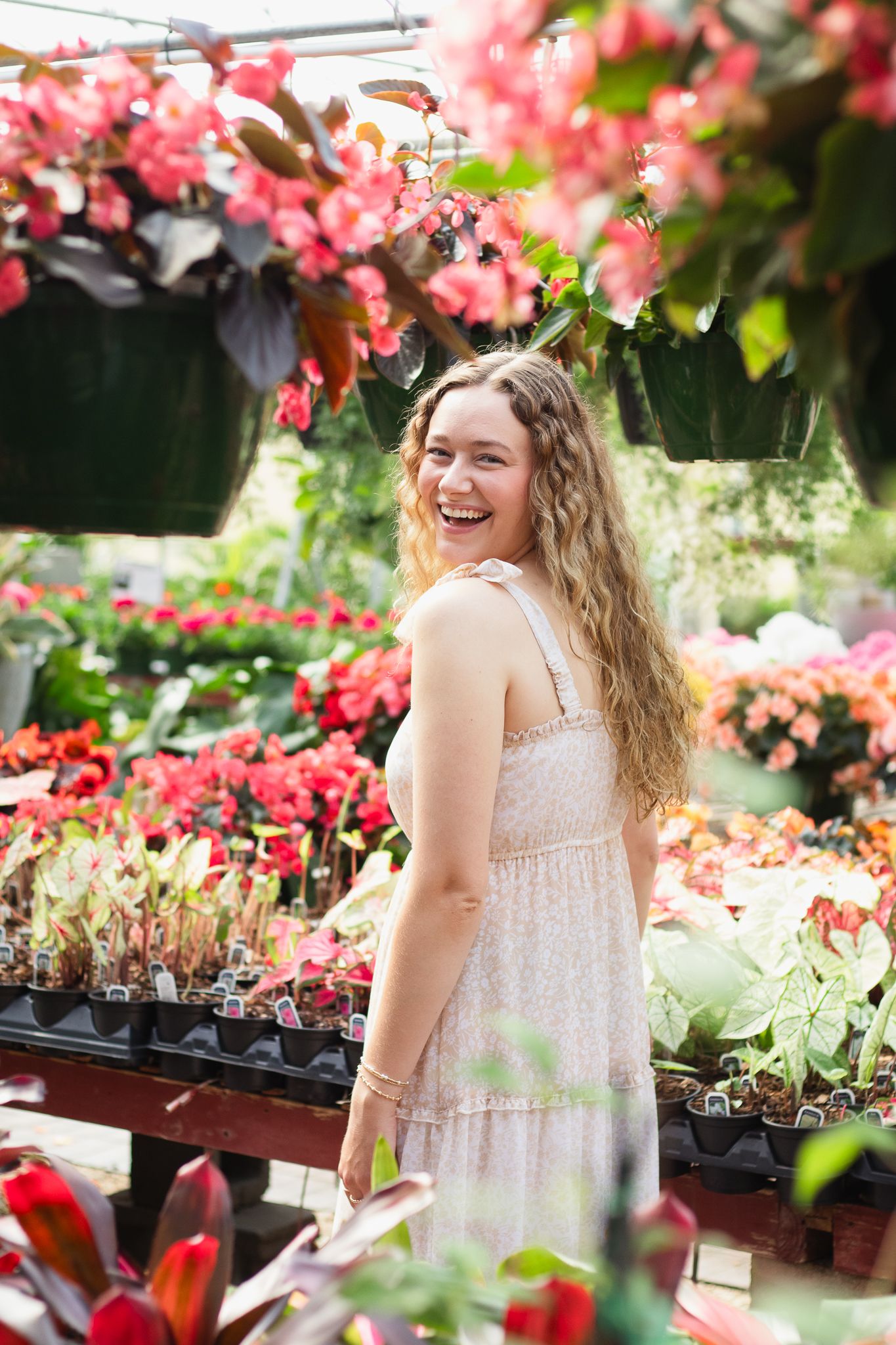 Blonde young adult posing for a South Carolina photographer in Florence, SC at a greenhouse photoshoot portraits. Candid and true-to-color
