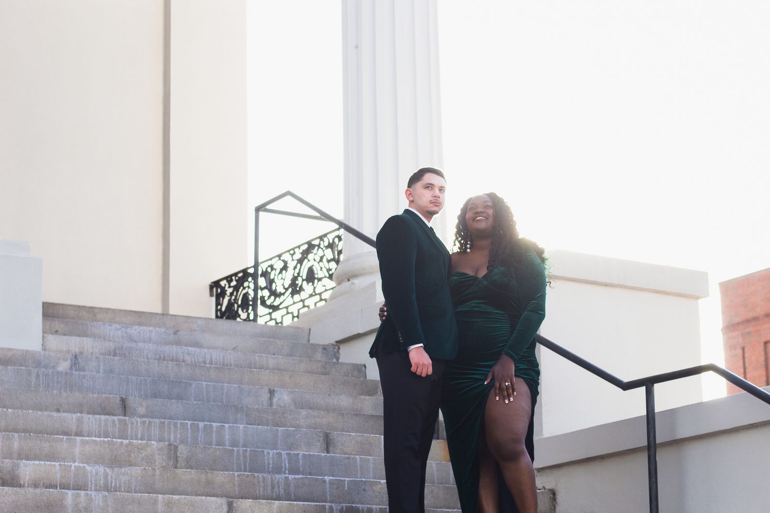 Couple posing for South Carolina photographer at downtown Greenville engagement portraits photoshoot. Candid true to color upstate sc formal