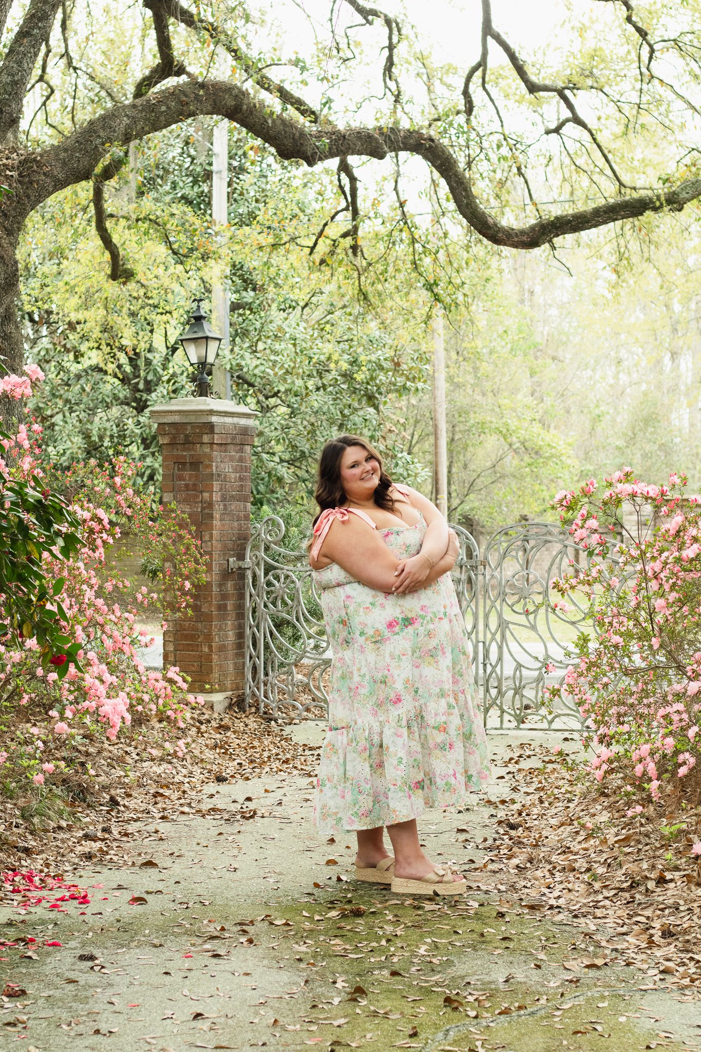 High school senior posing for a South Carolina photographer in Hartsville, SC for their senior pictures graduation portraits. garden candid