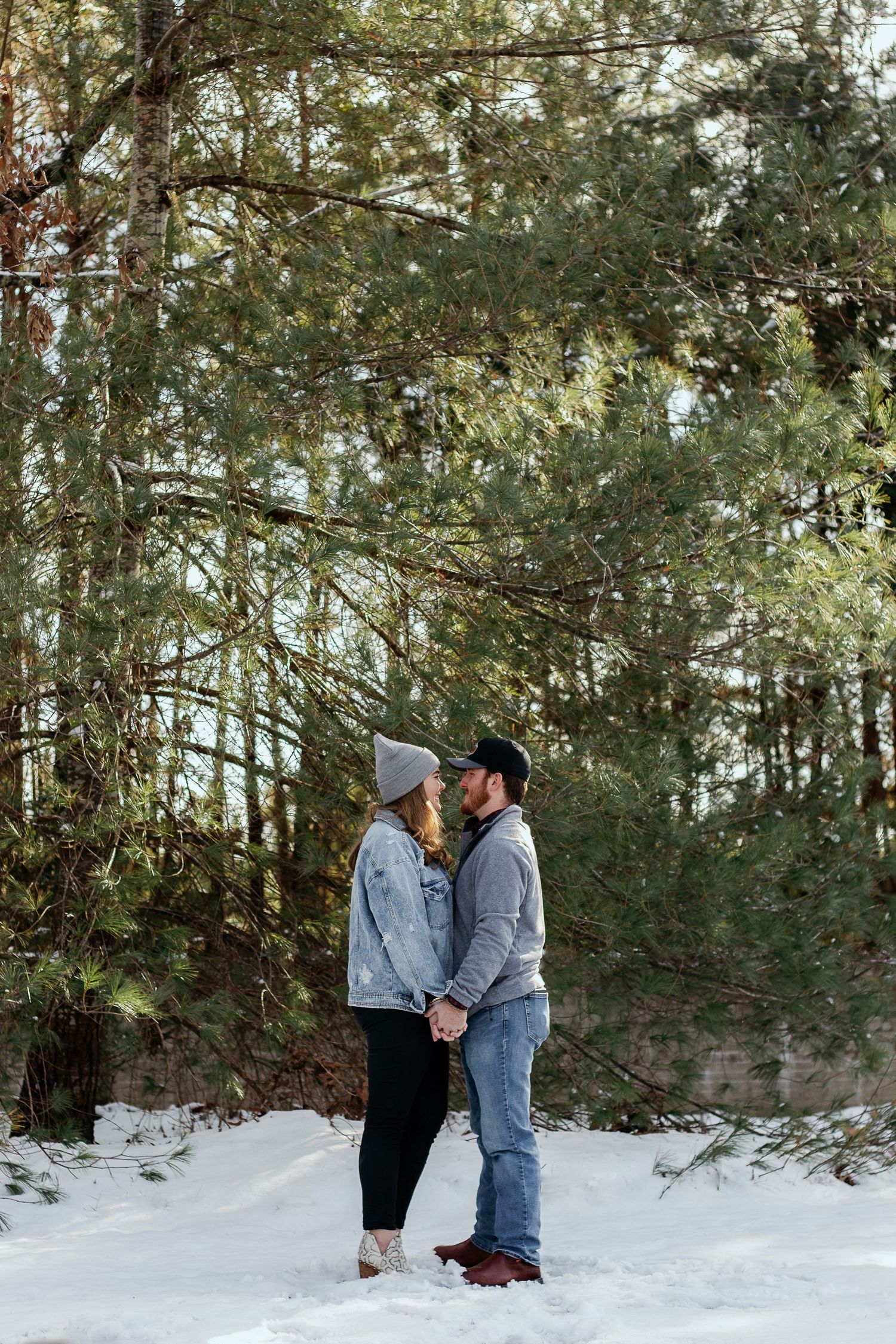 Couple posing for South Carolina photographer in snow in Florence winter engagement portraits photoshoot. Candid true to color upstate sc