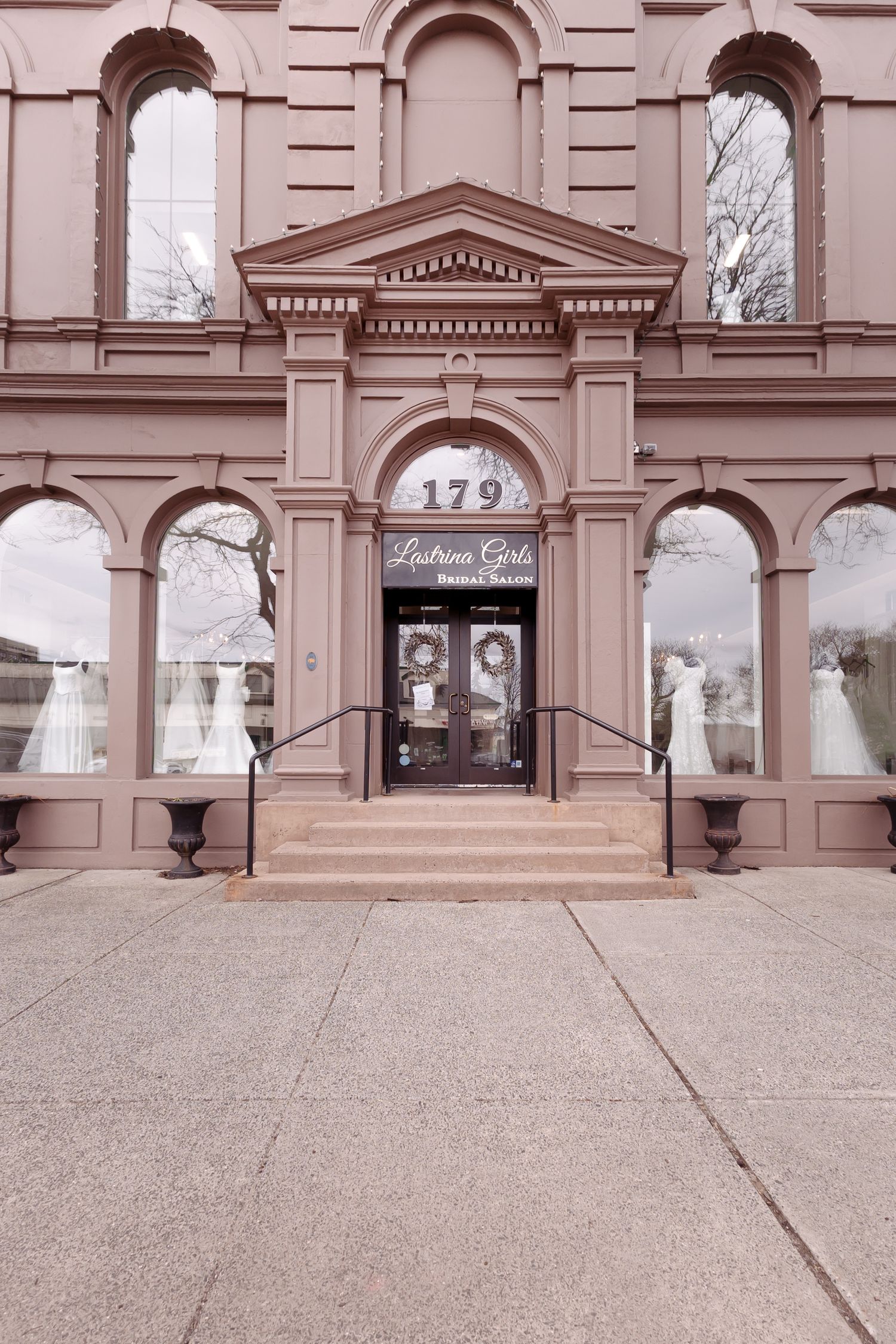 Elegant bridal salon at 179 featuring ornate Victorian architecture, large display windows with wedding gowns, and grand entrance steps.
