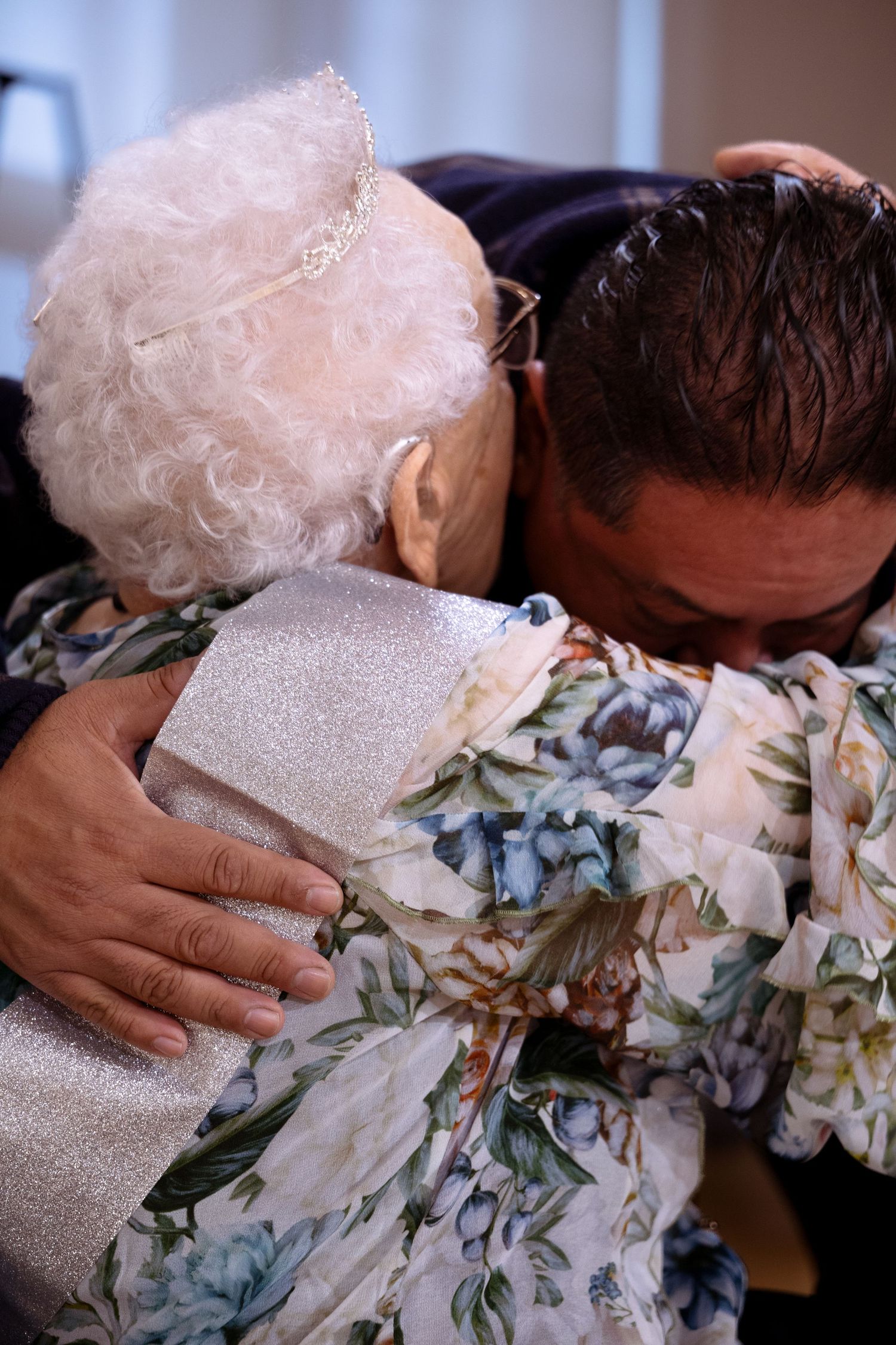 A series of intimate moments showing hands touching a floral patterned fabric with a white lace overlay.